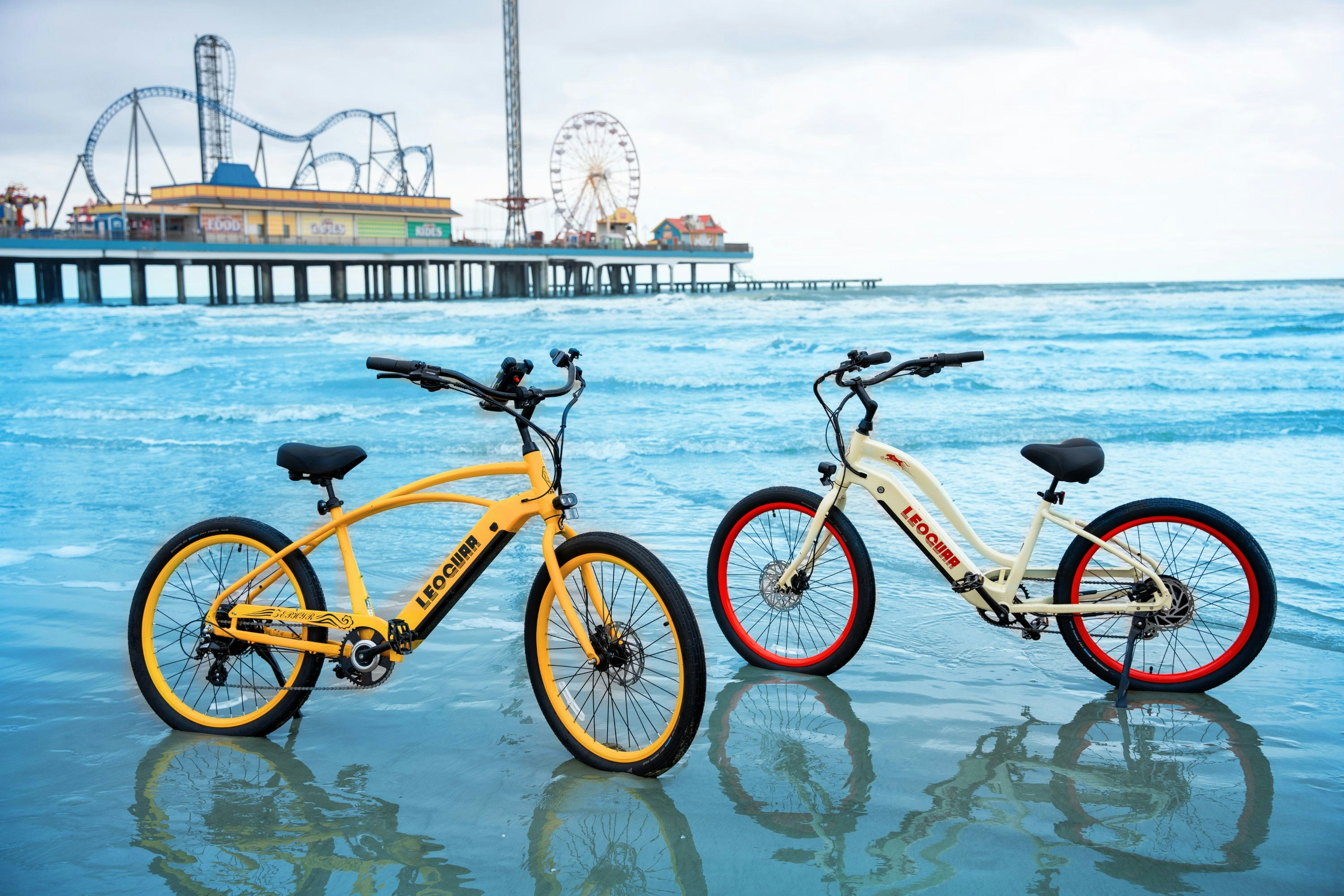 Two bikes parked next to each other on a beach