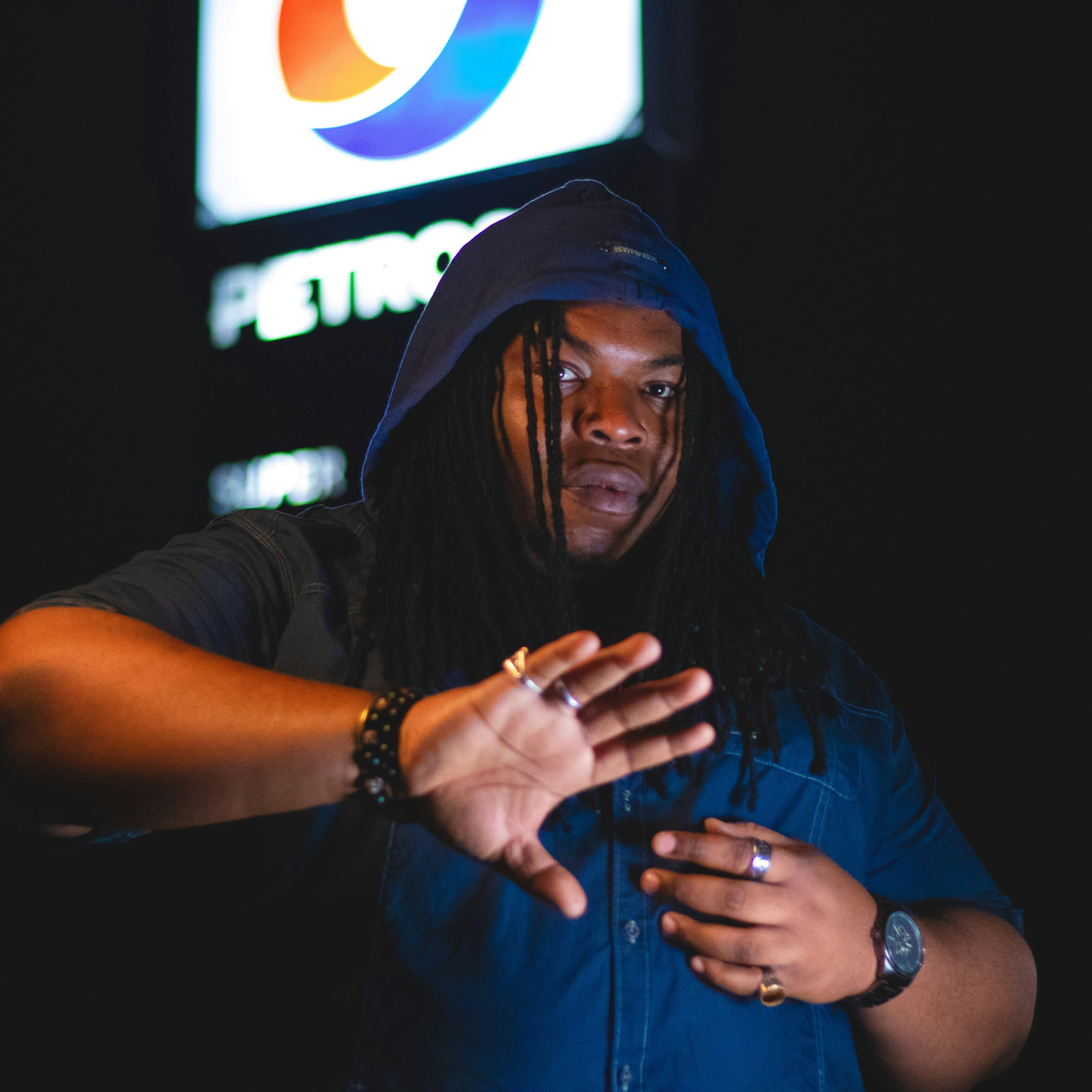 A man standing in front of a pepsi sign