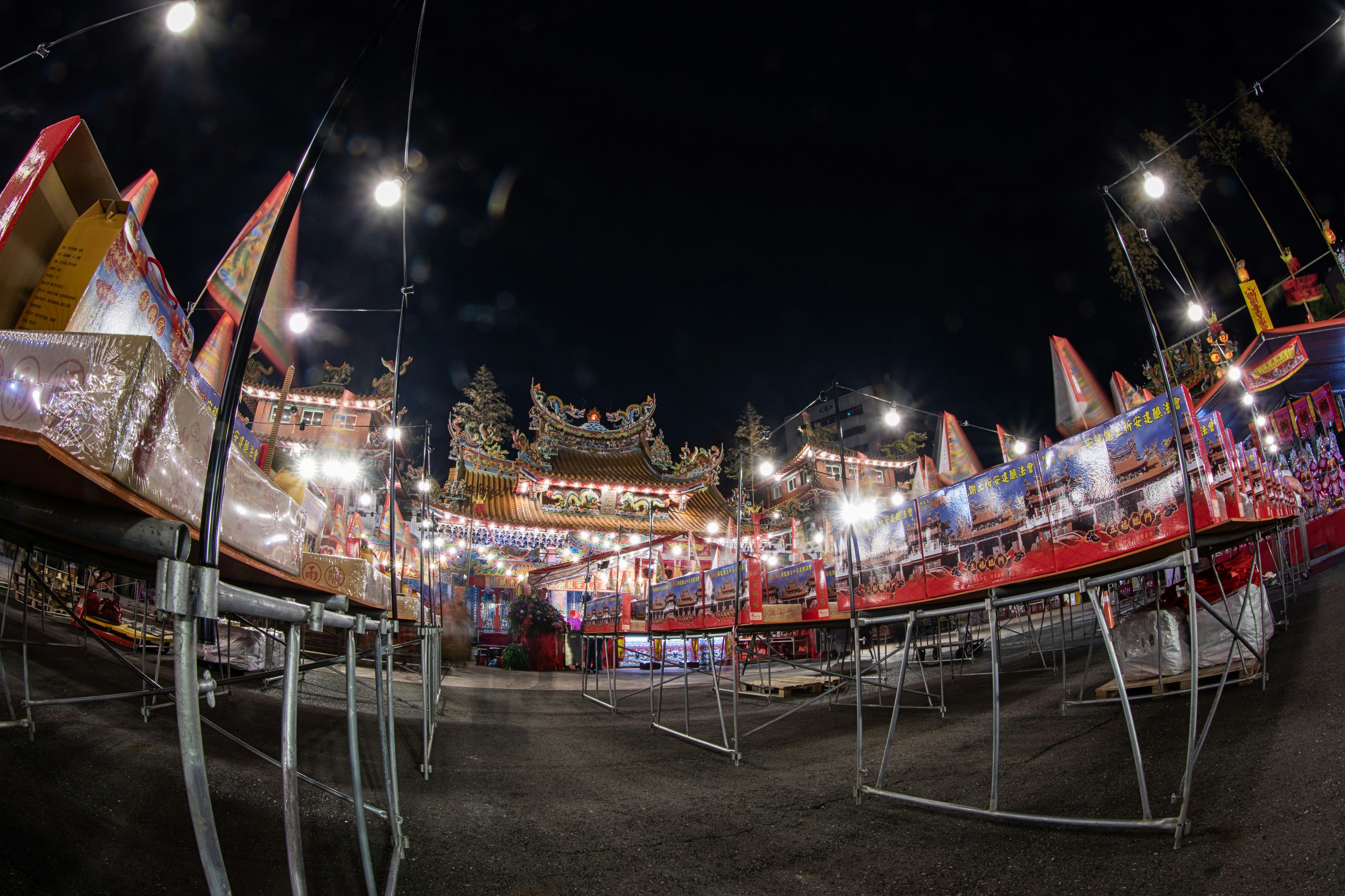 A carnival filled with lots of people at night