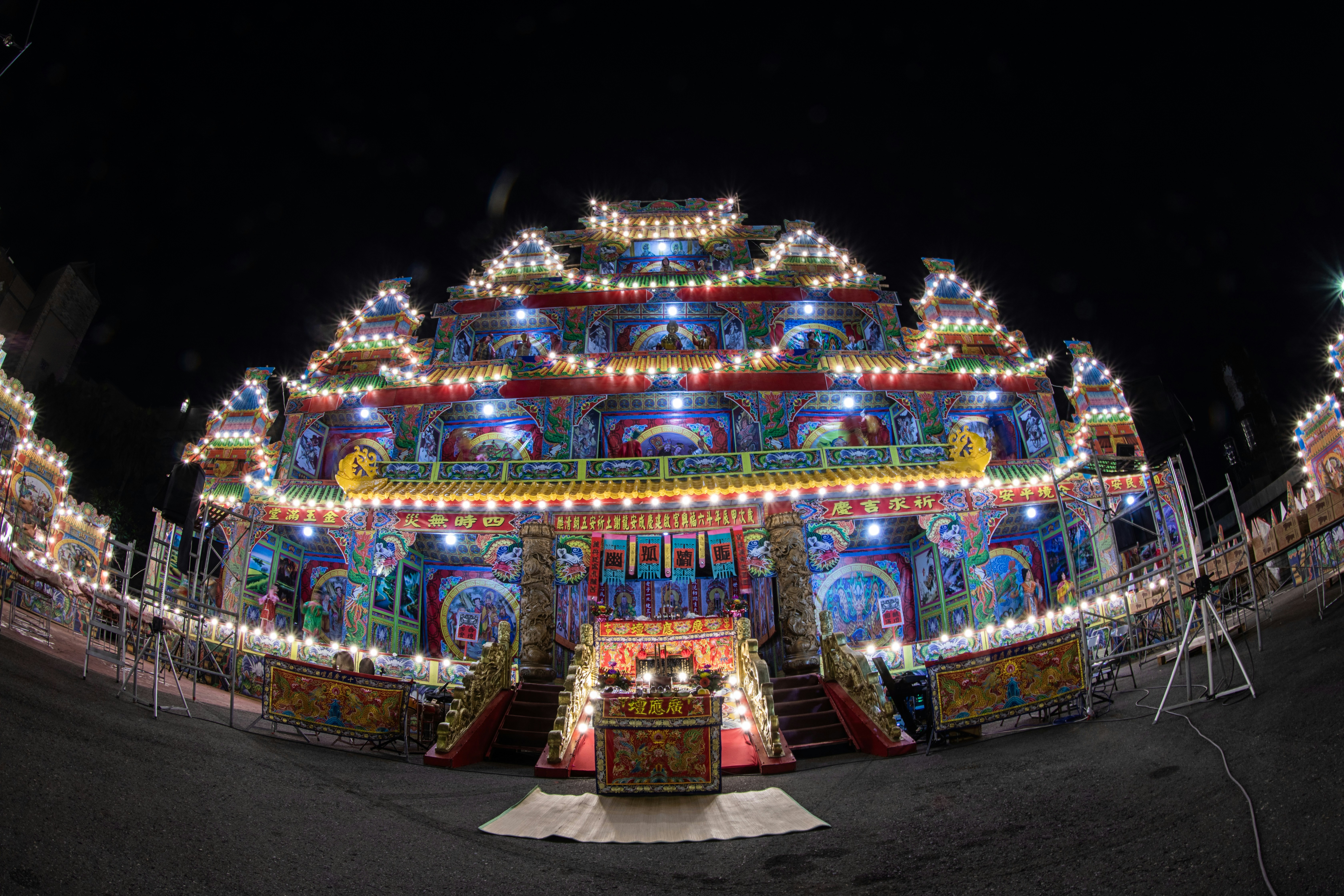 A brightly lit carnival ride at night time