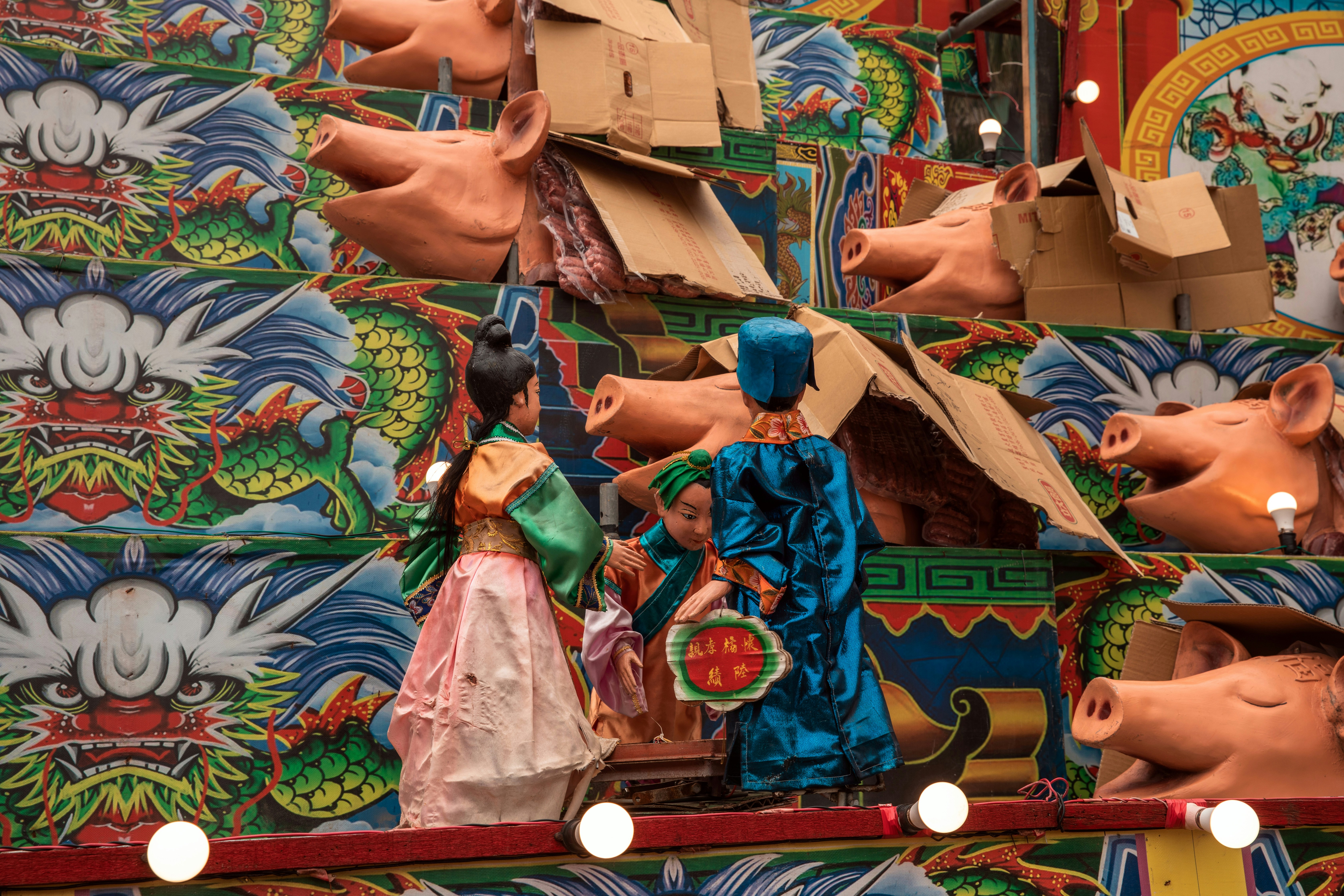 A group of wooden pigs on display in a store