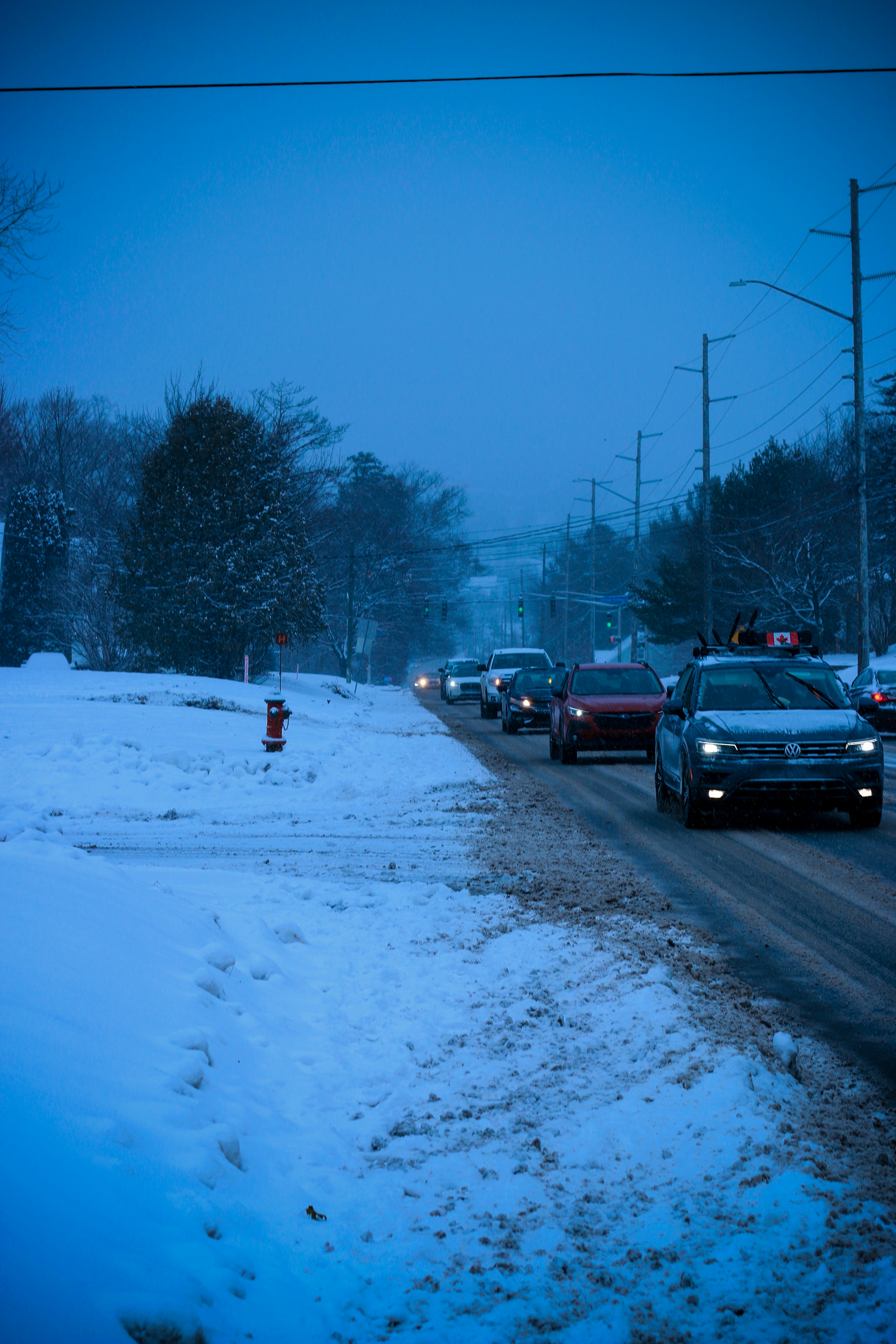 A bunch of cars that are sitting in the snow