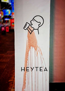 A sign with a picture of a man holding a paintbrush