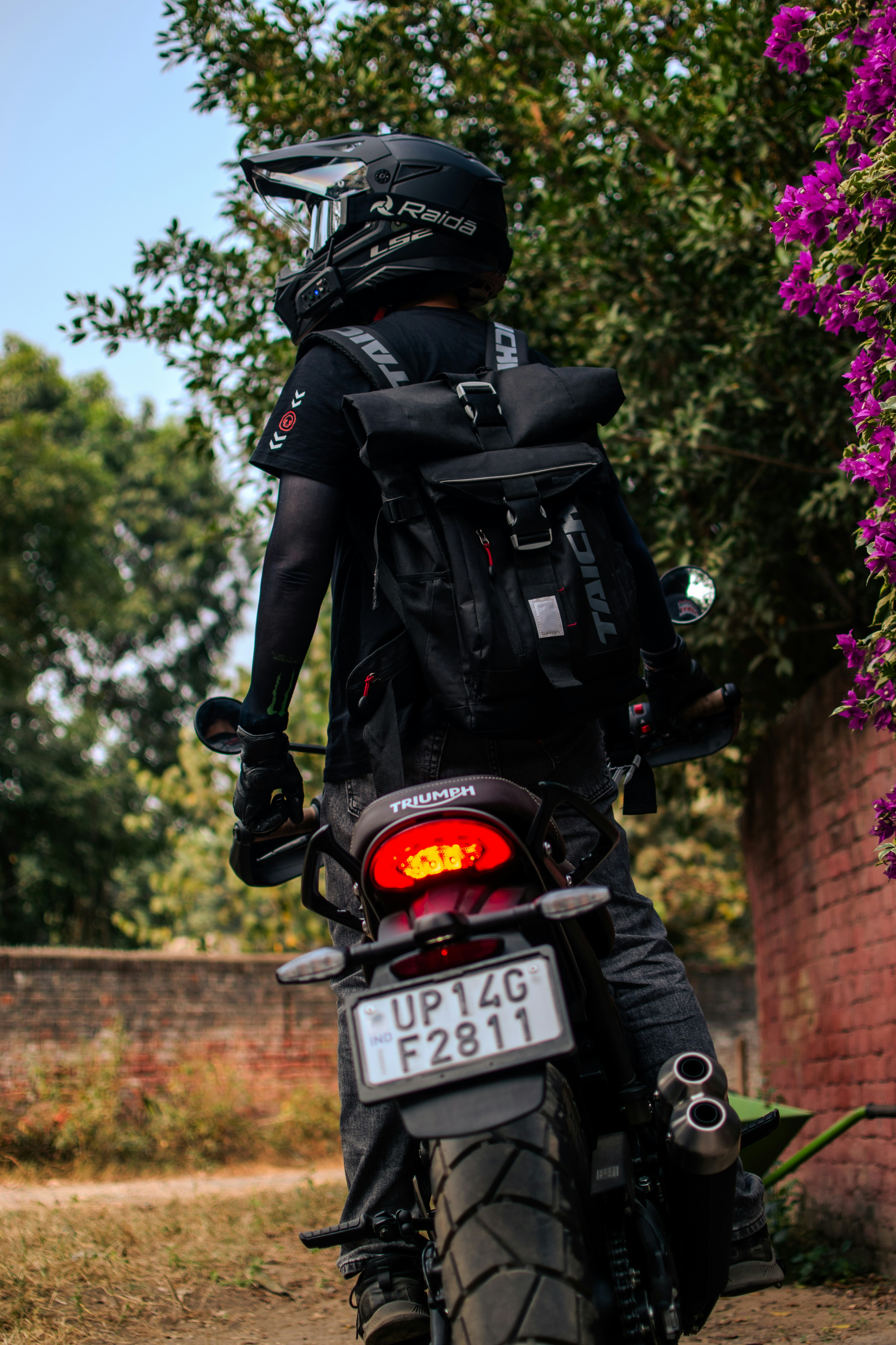 A man riding a motorcycle down a street