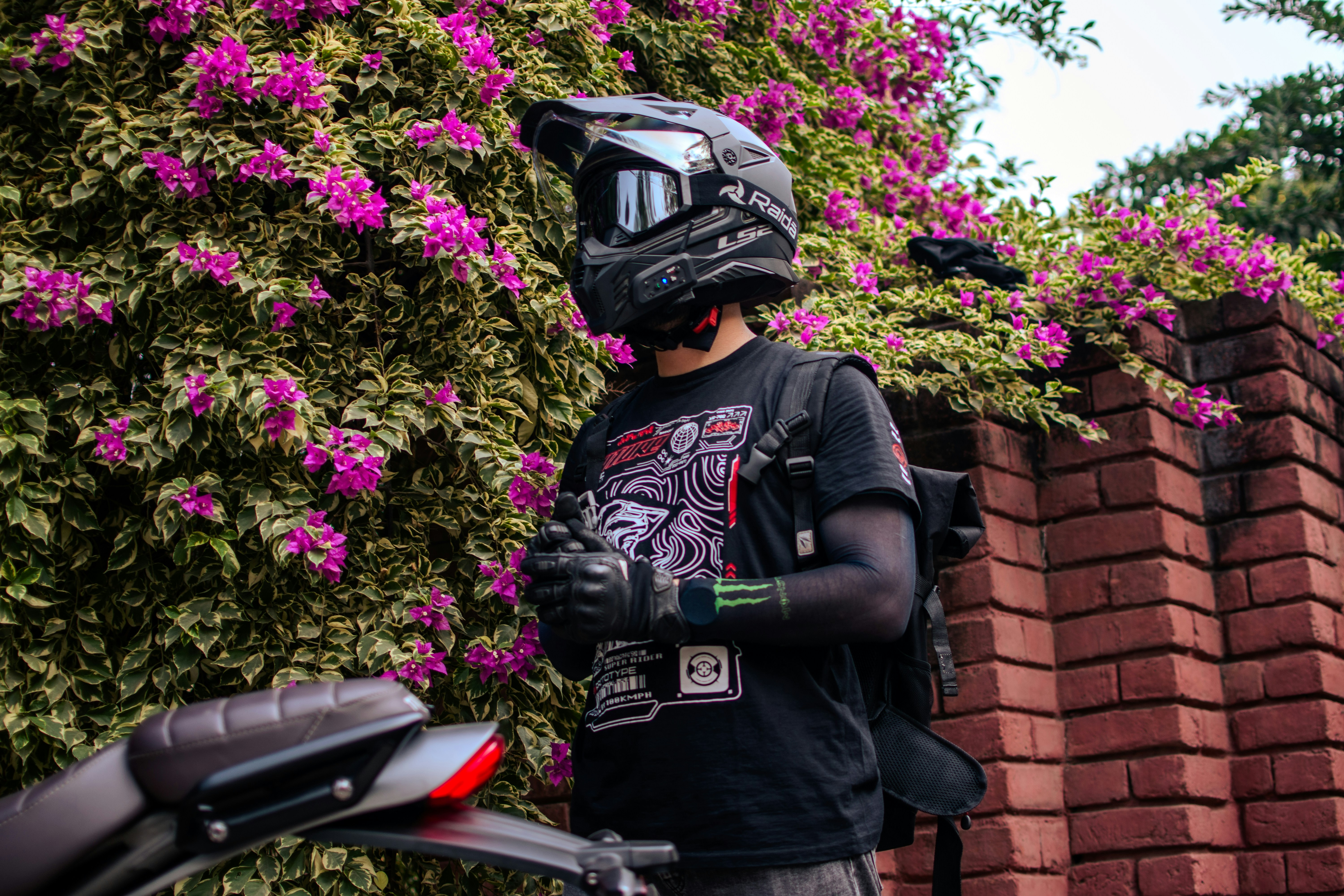A man standing next to a motorcycle with a helmet on