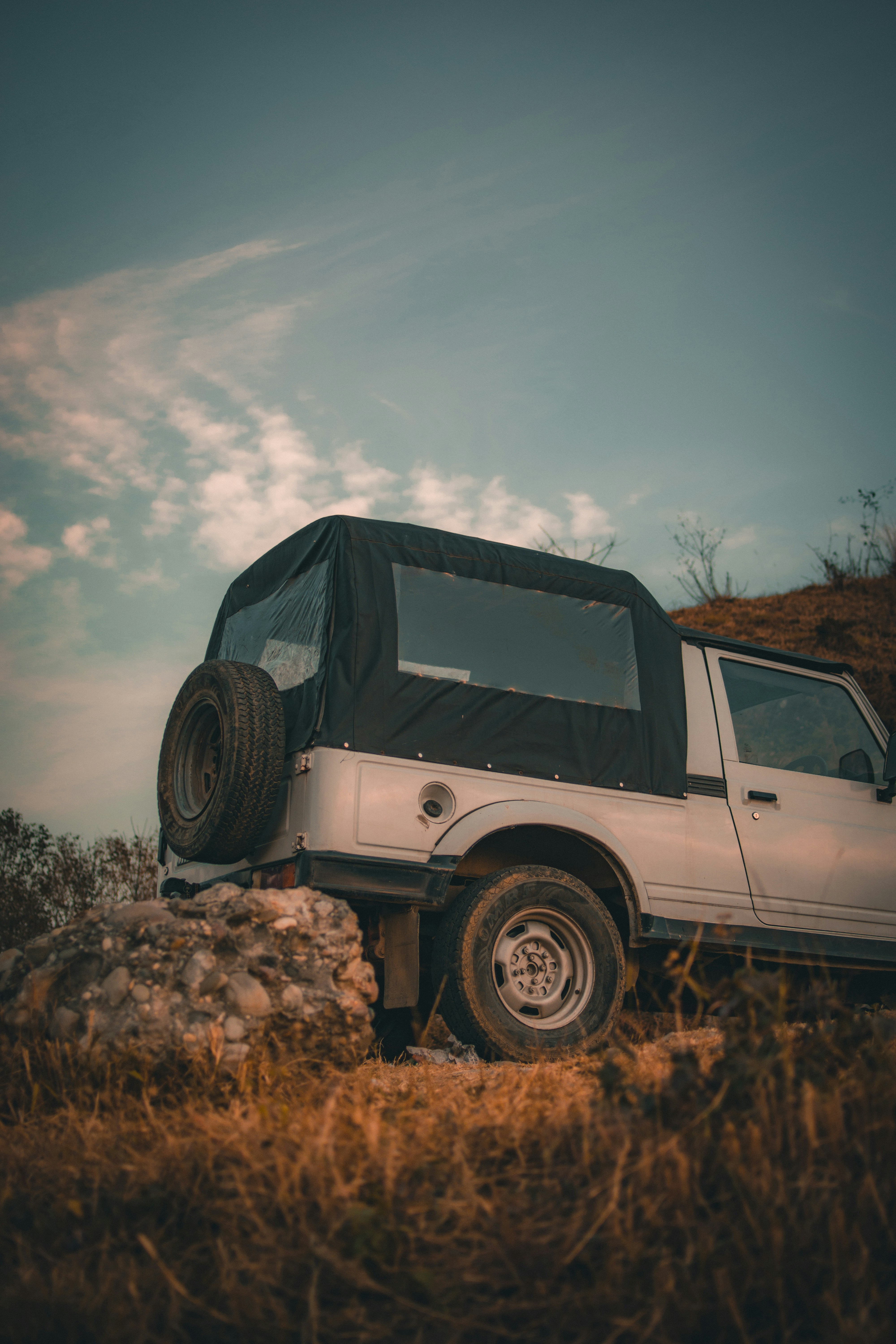 A white truck with a flat tire on the back of it