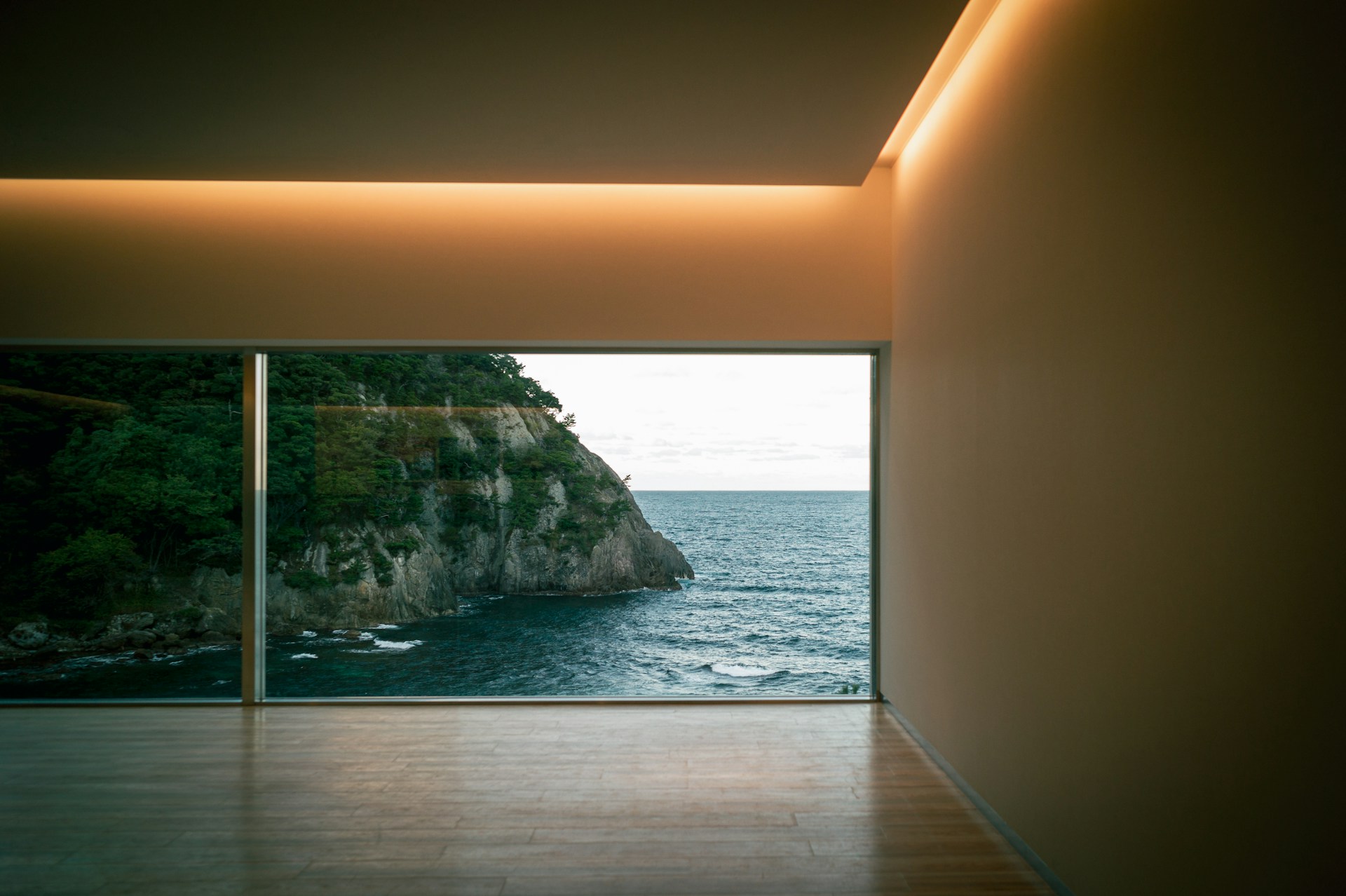 An empty room with a view of the ocean