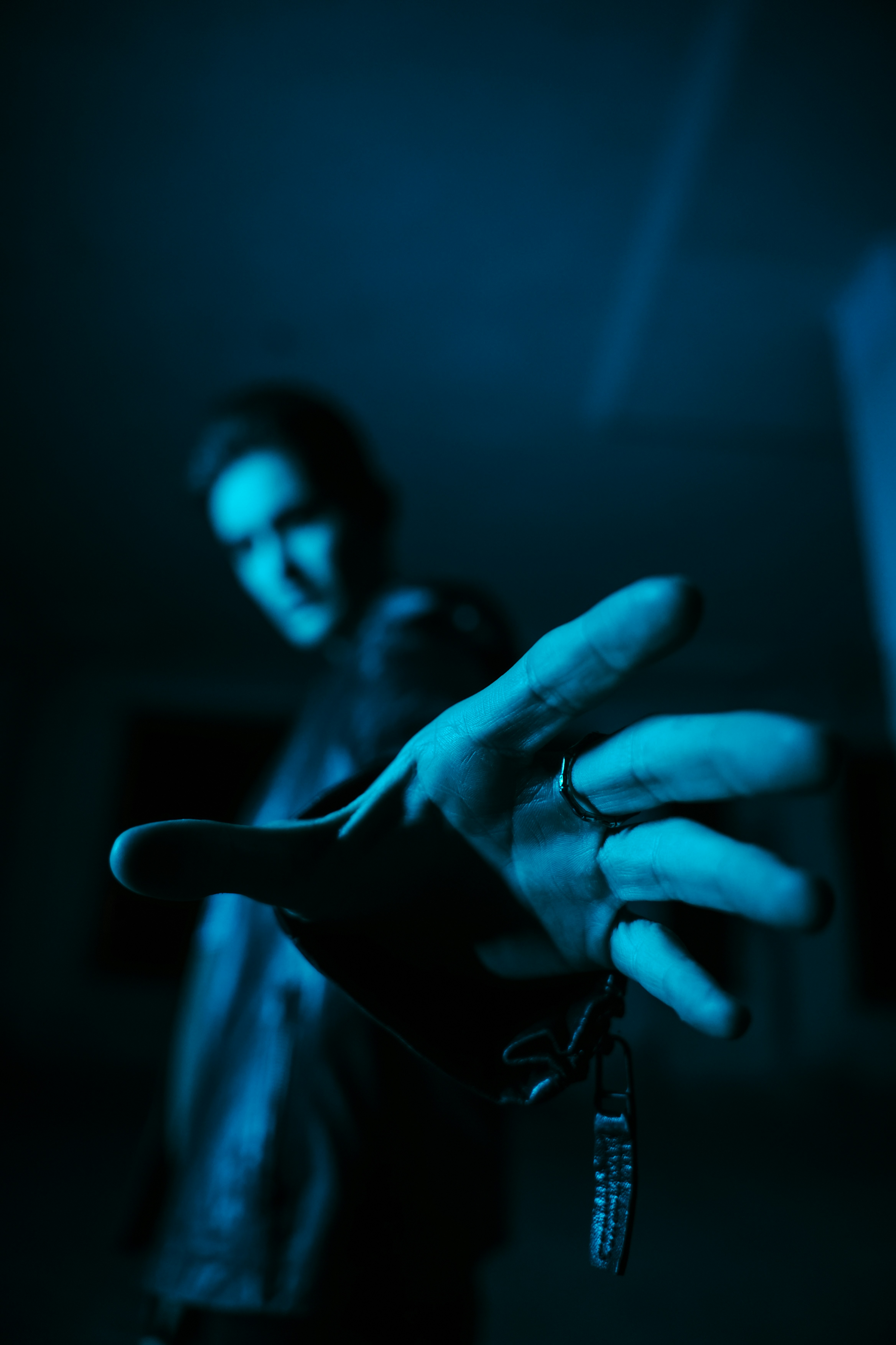 A person holding a pair of scissors in their hand