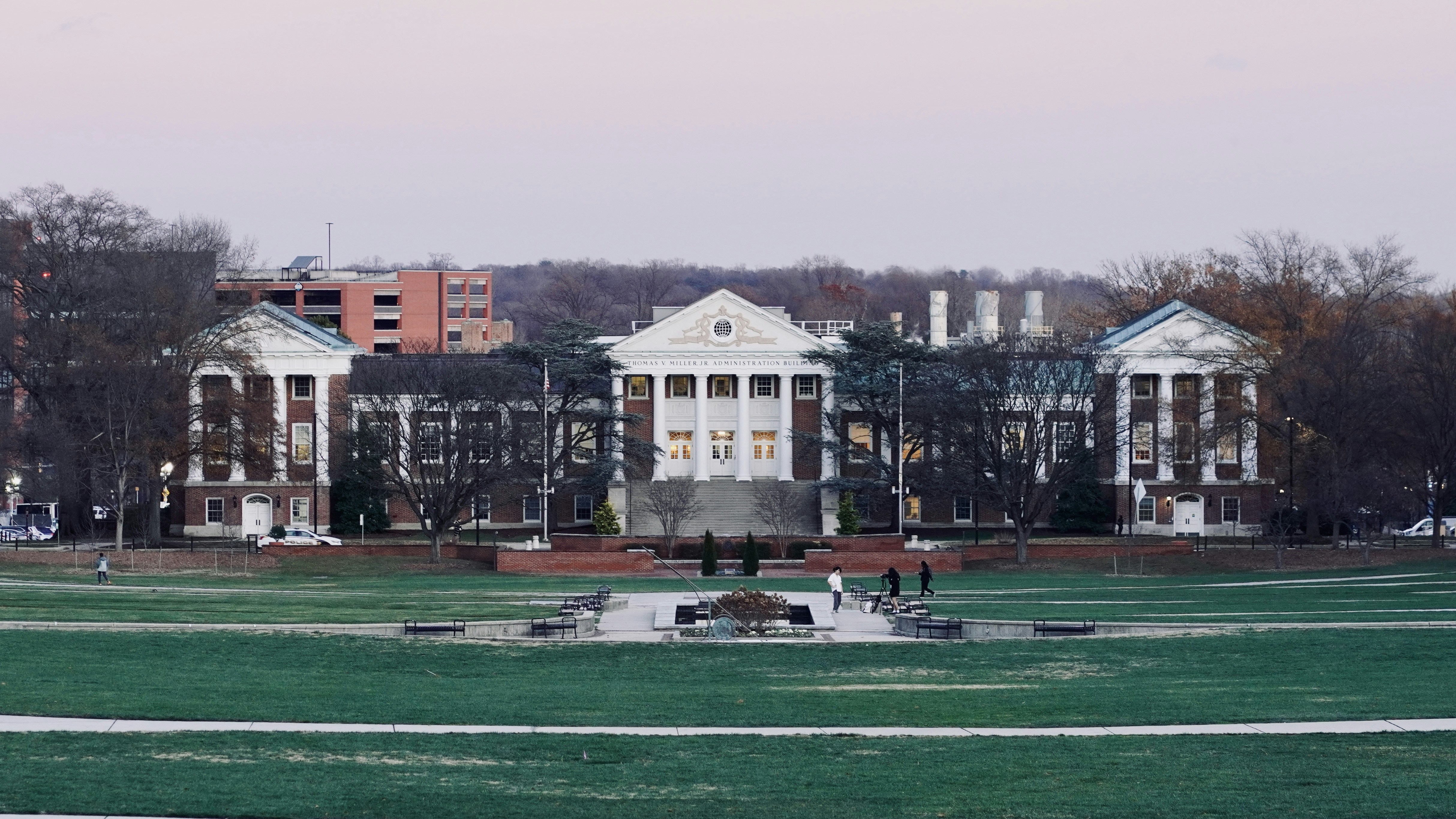 A large building with a fountain in front of it