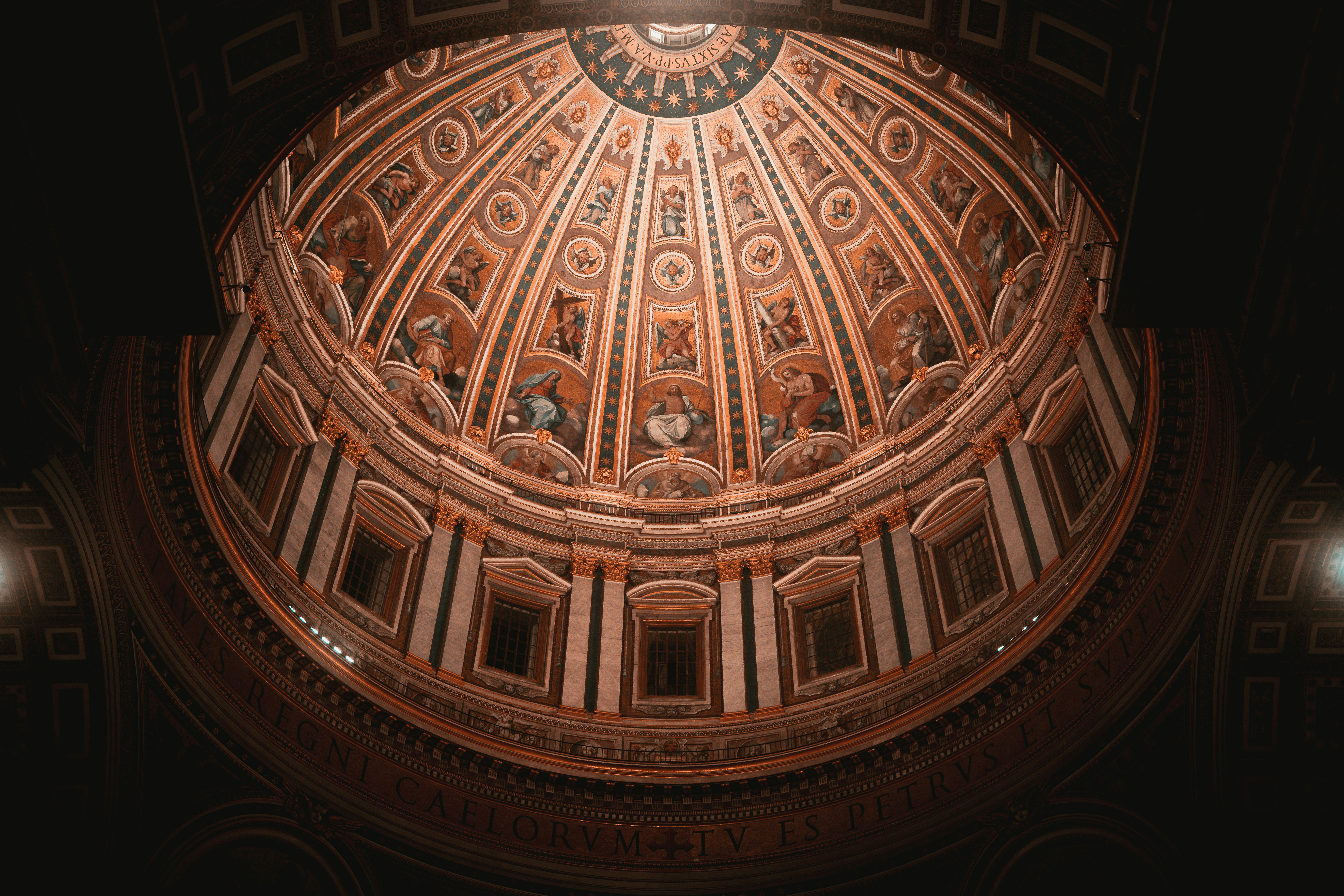 The ceiling of a building with a clock on it