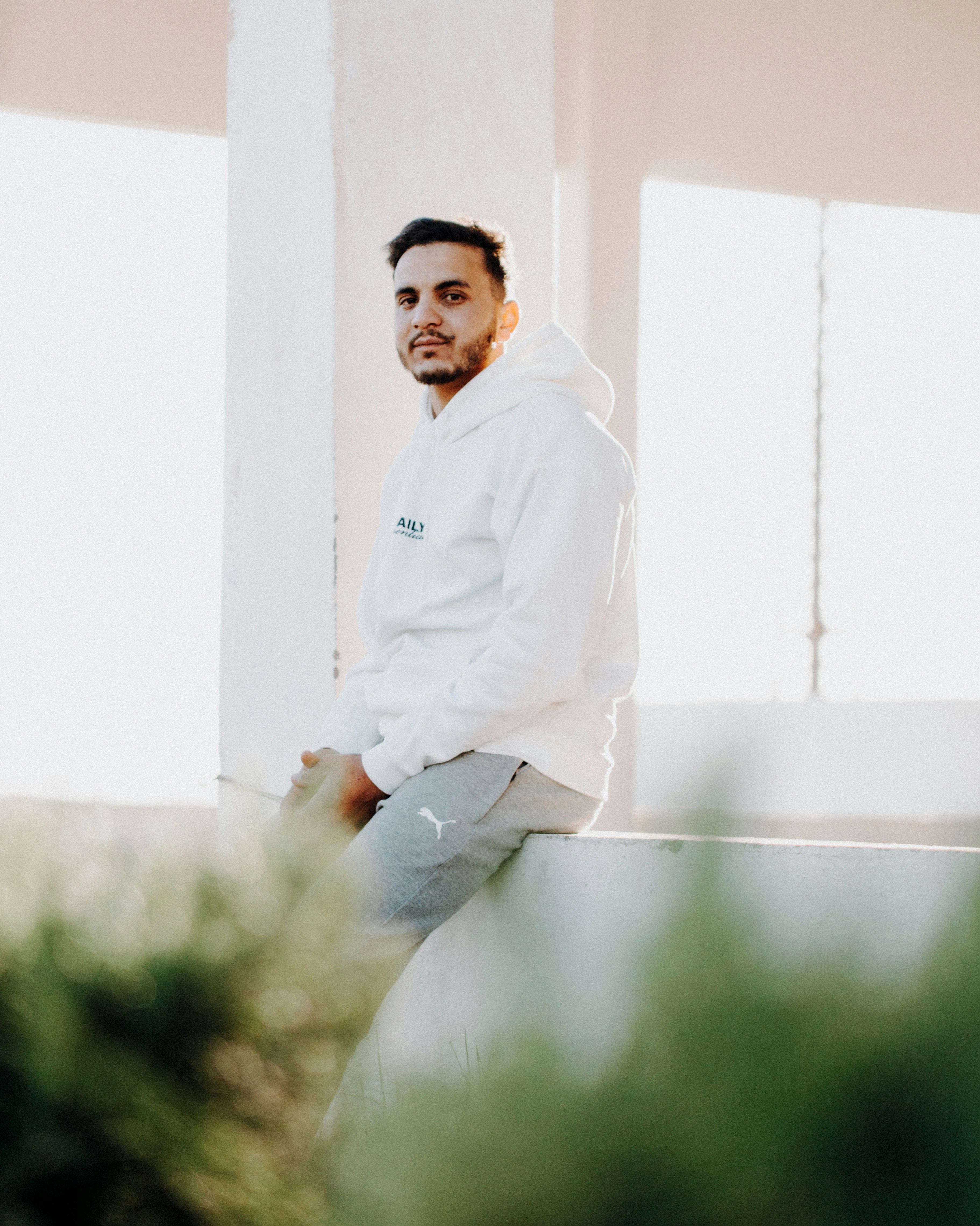 A man sitting on a ledge in a building