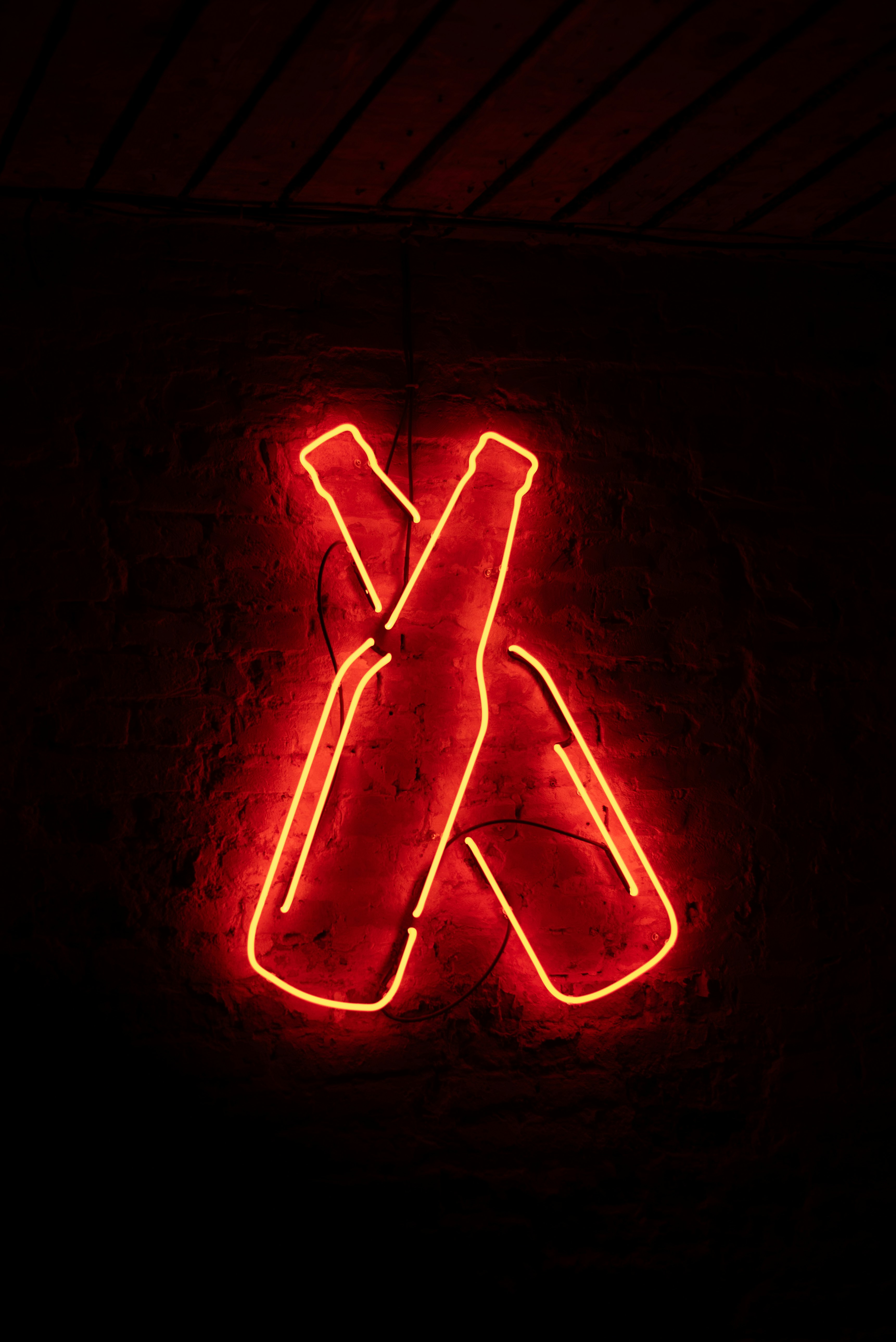 A neon sign that is on the side of a building