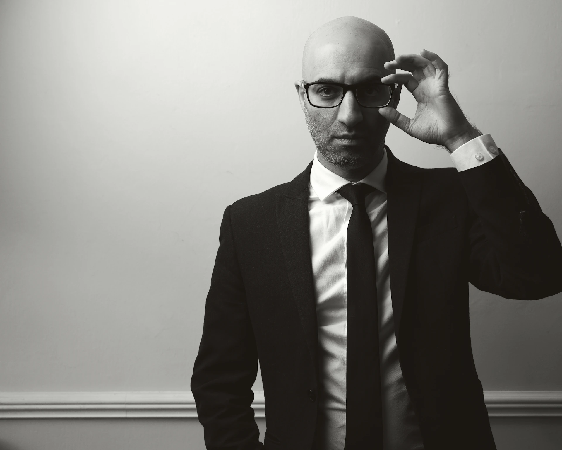 A bald man in a suit and tie