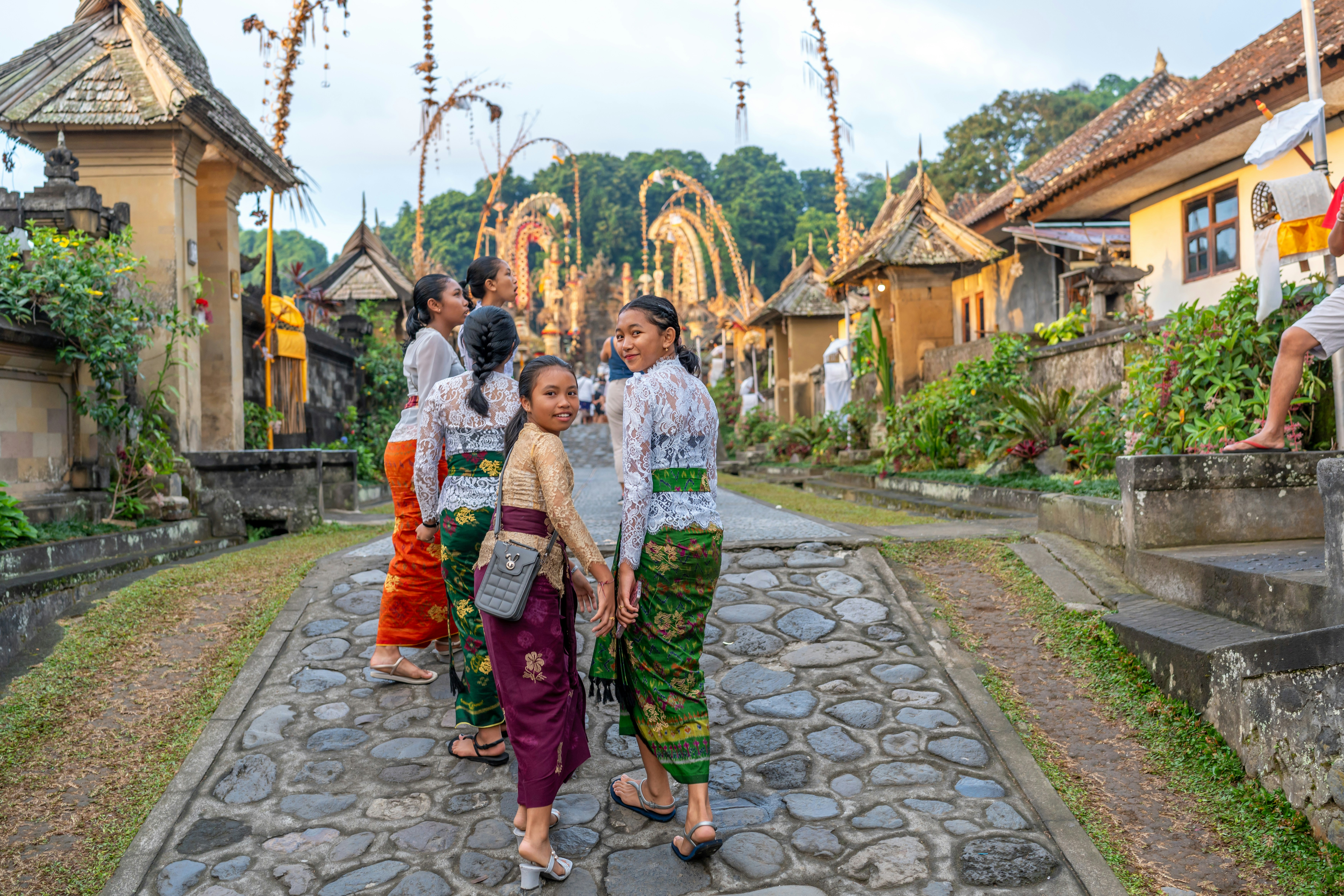 Eine Gruppe von Menschen geht eine Kopfsteinpflasterstraße entlang