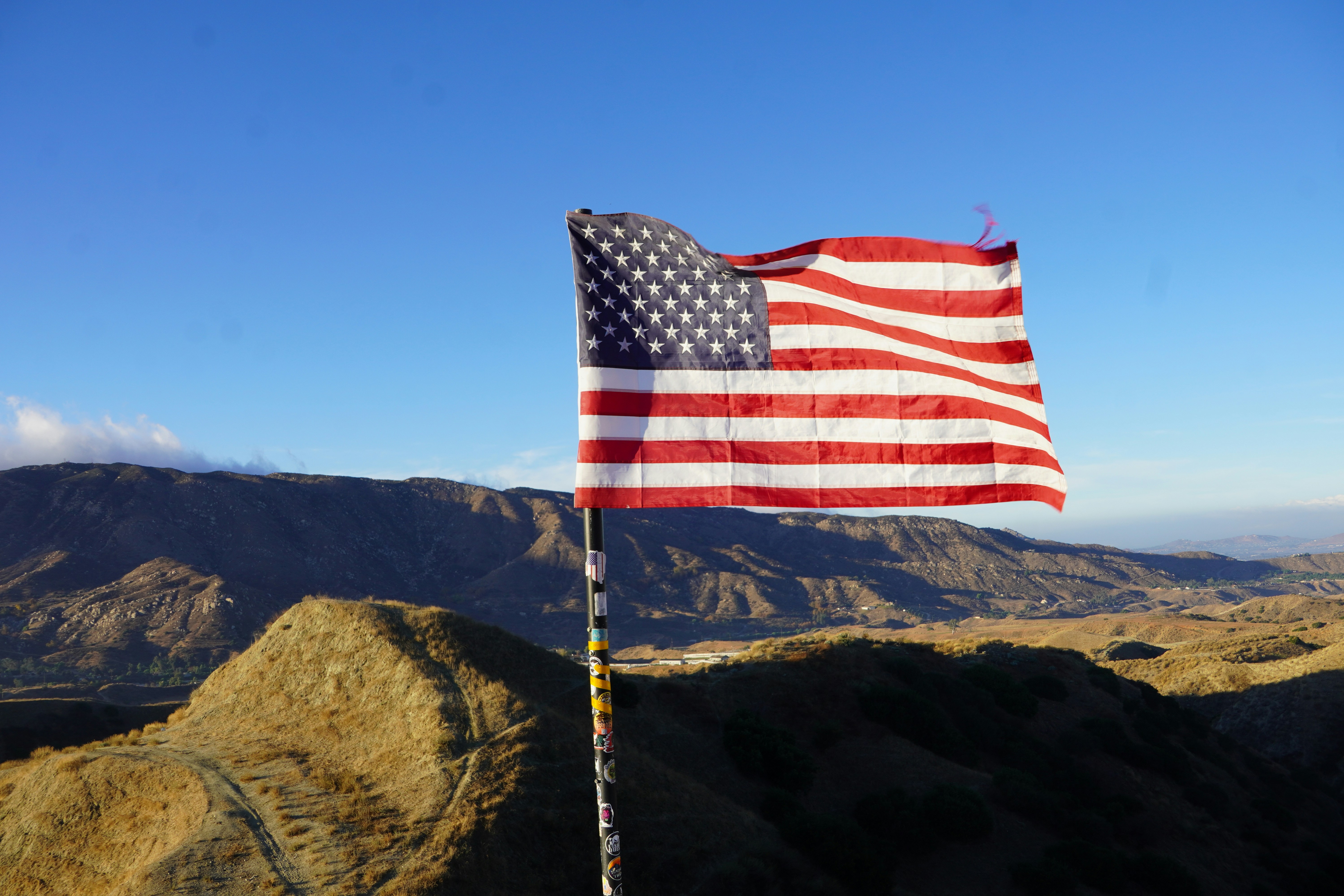 An american flag on top of a mountain