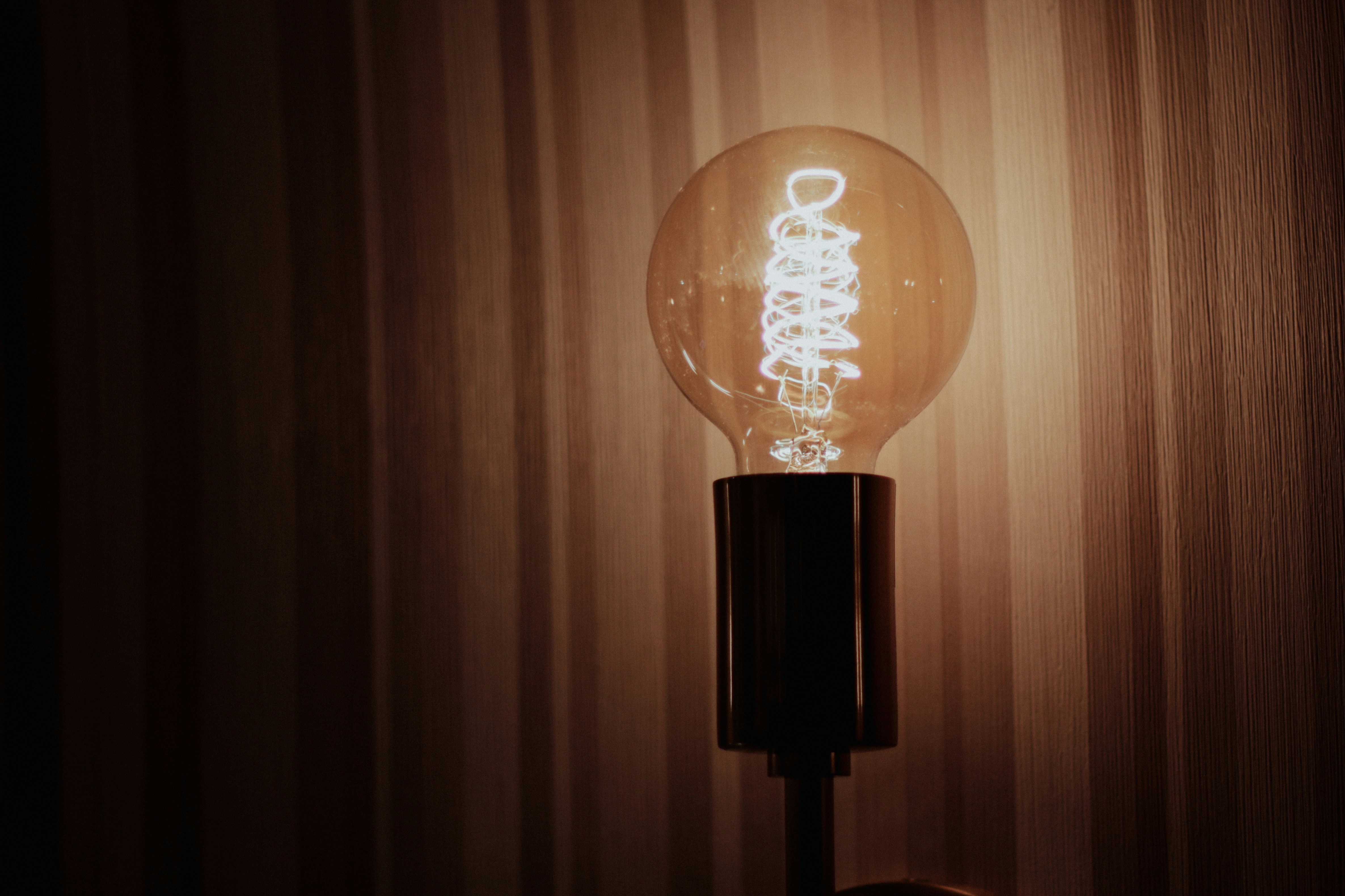 A light bulb sitting on top of a wooden table