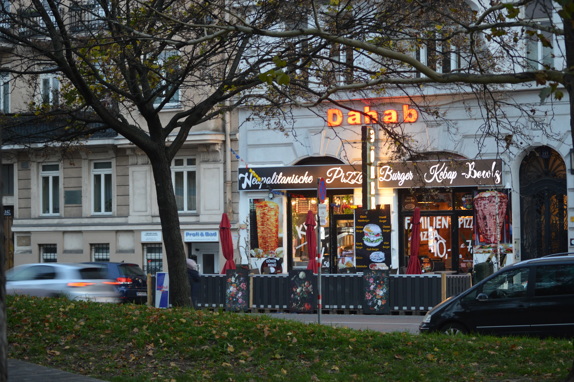 A street corner with cars parked on the side of the road