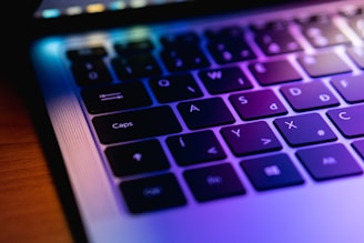 A close up of a laptop keyboard on a table