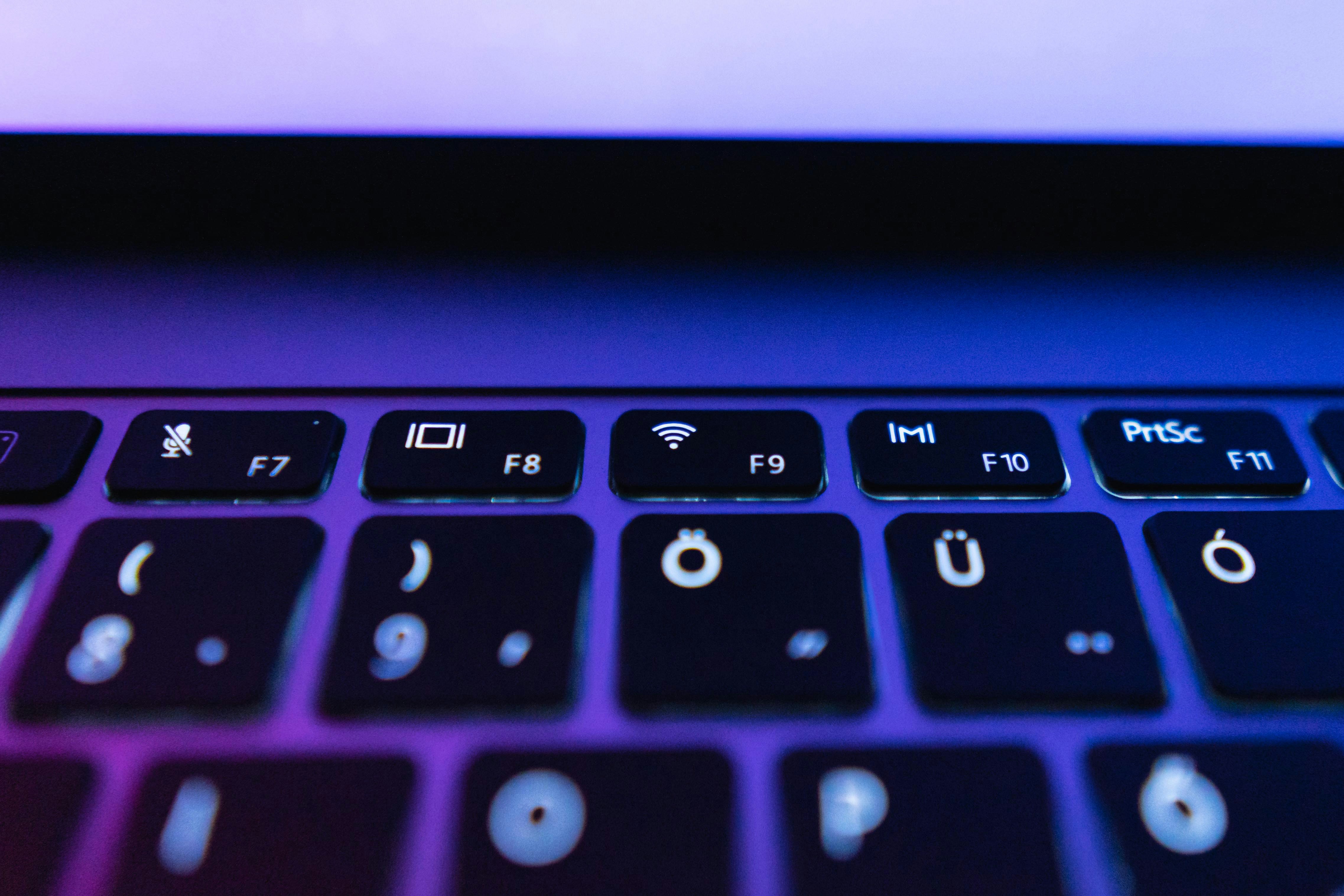 Laptop keyboard with purple light