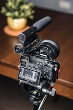 A video camera sitting on top of a wooden table