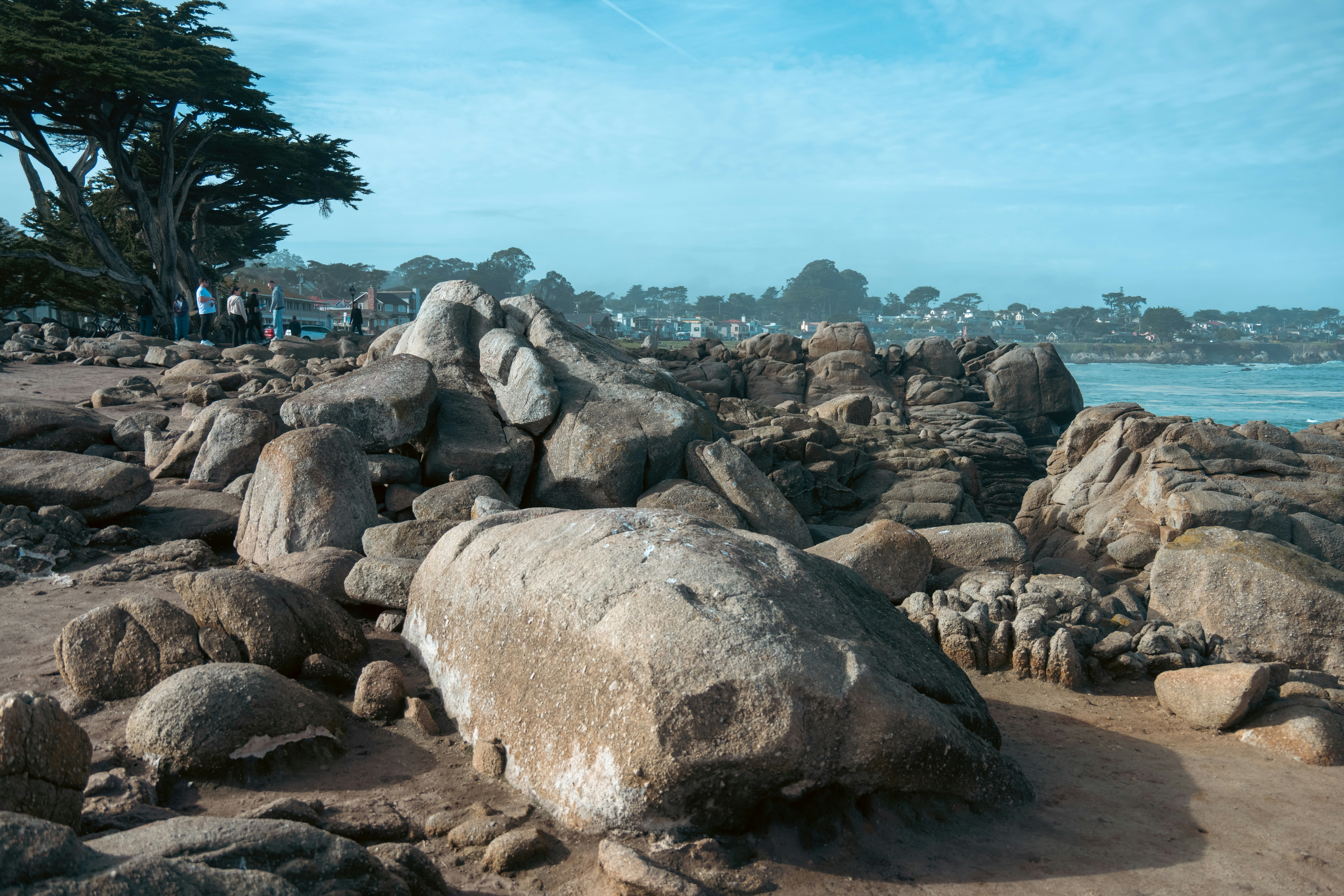 A large rock sitting on top of a sandy beach photo – Free Human Image ...
