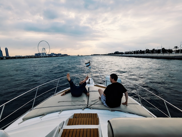Two people sitting on a boat in the water