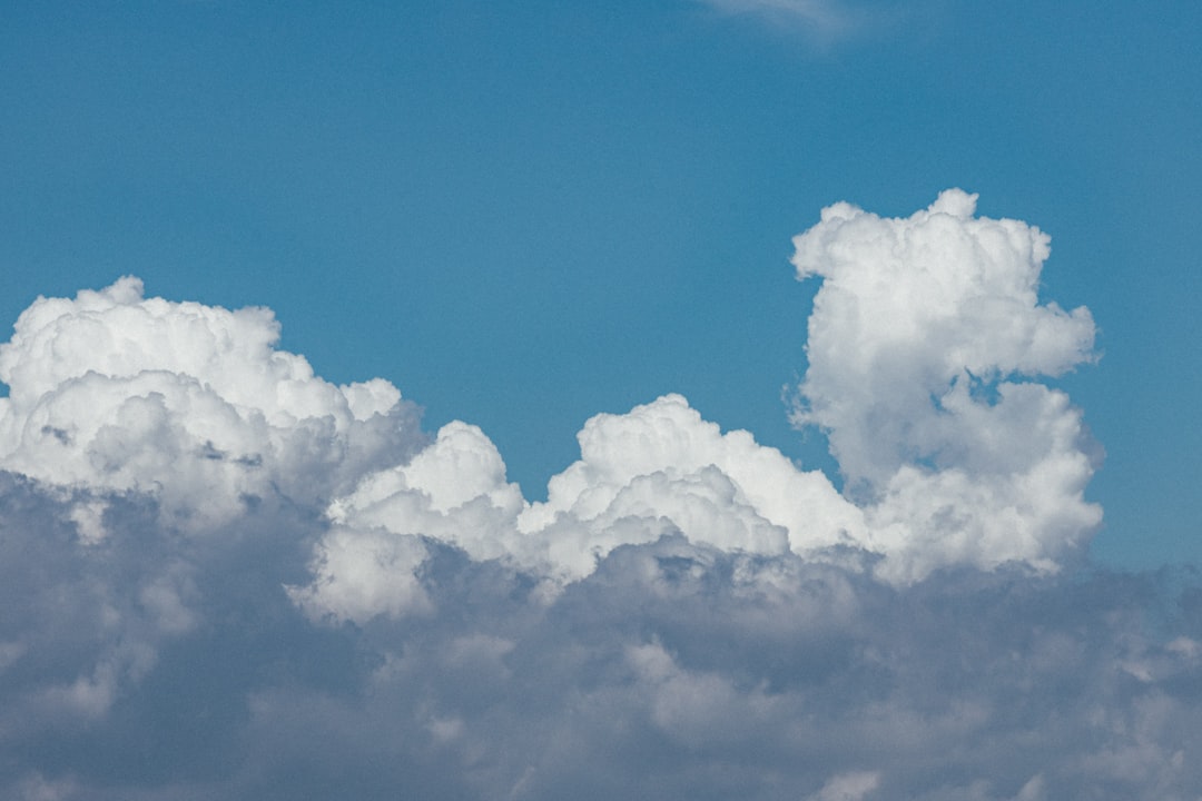 A plane flying in the sky with a lot of clouds,