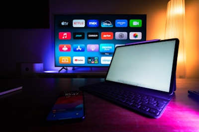 A laptop computer sitting on top of a wooden desk