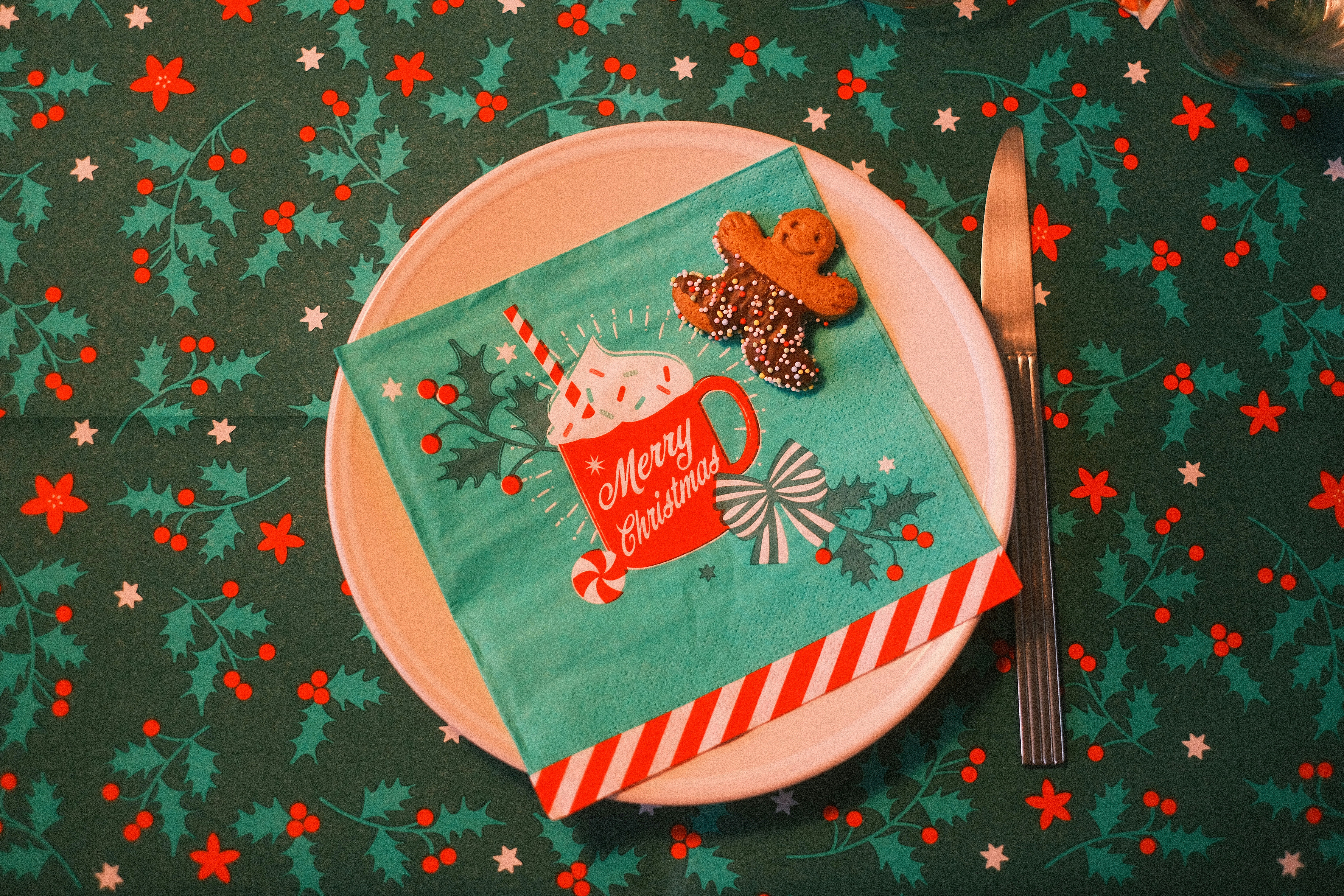 A plate with a napkin on it with a cupcake on it