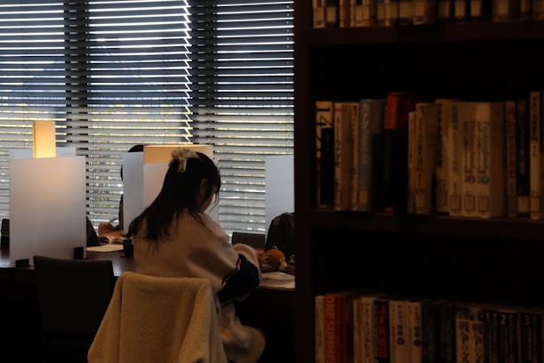 A woman sitting in a chair in front of a window