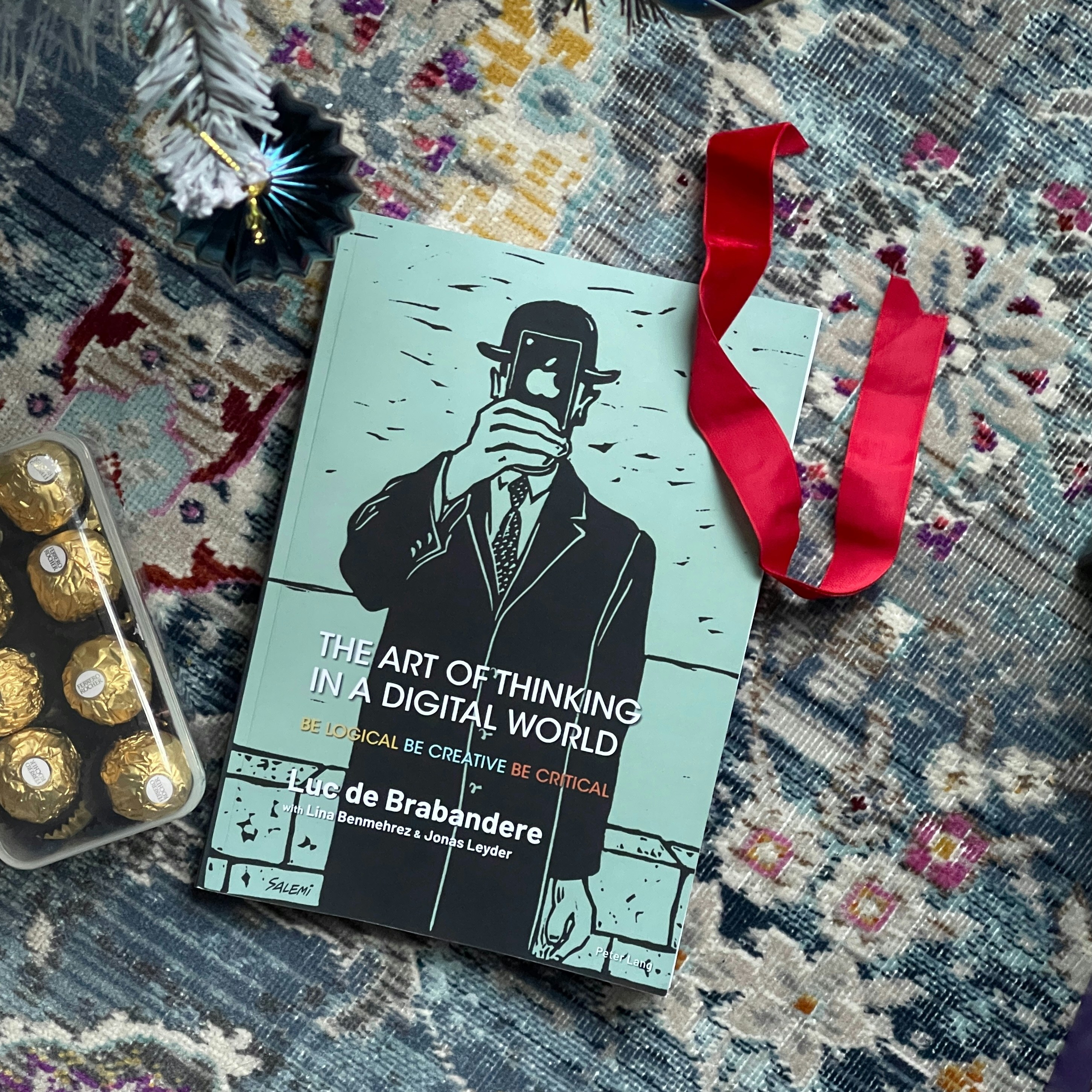 A book sitting on top of a rug next to a pair of scissors