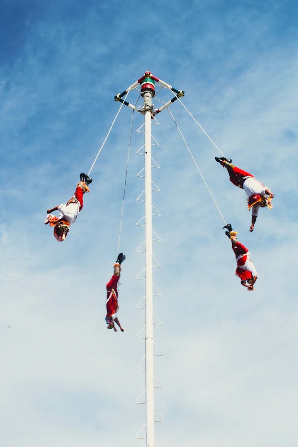 A group of people doing tricks on a pole