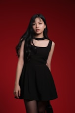 A woman in a black dress posing for a picture