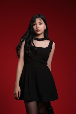 A woman in a black dress posing for a picture