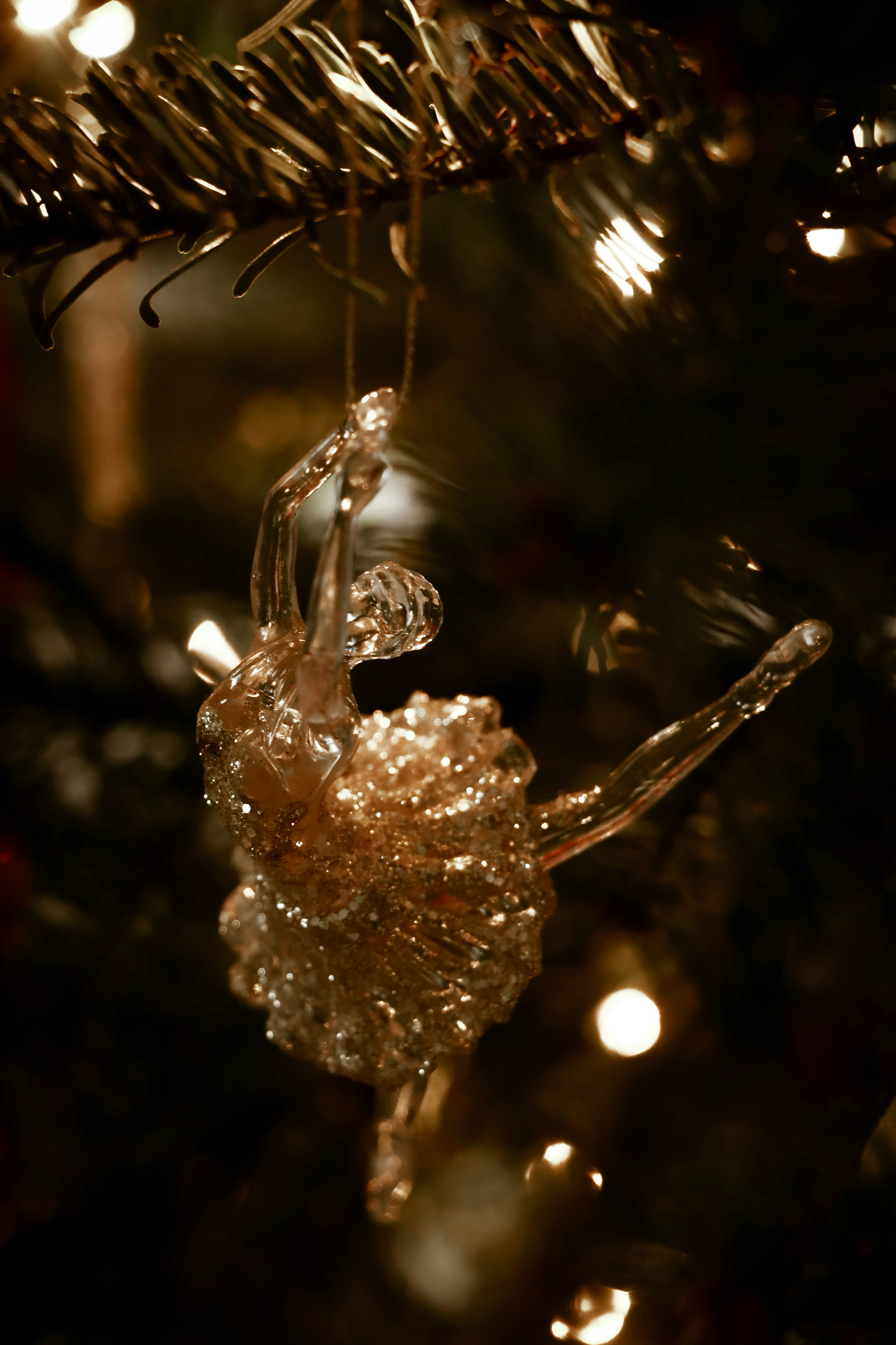 A glass ornament hanging from a christmas tree