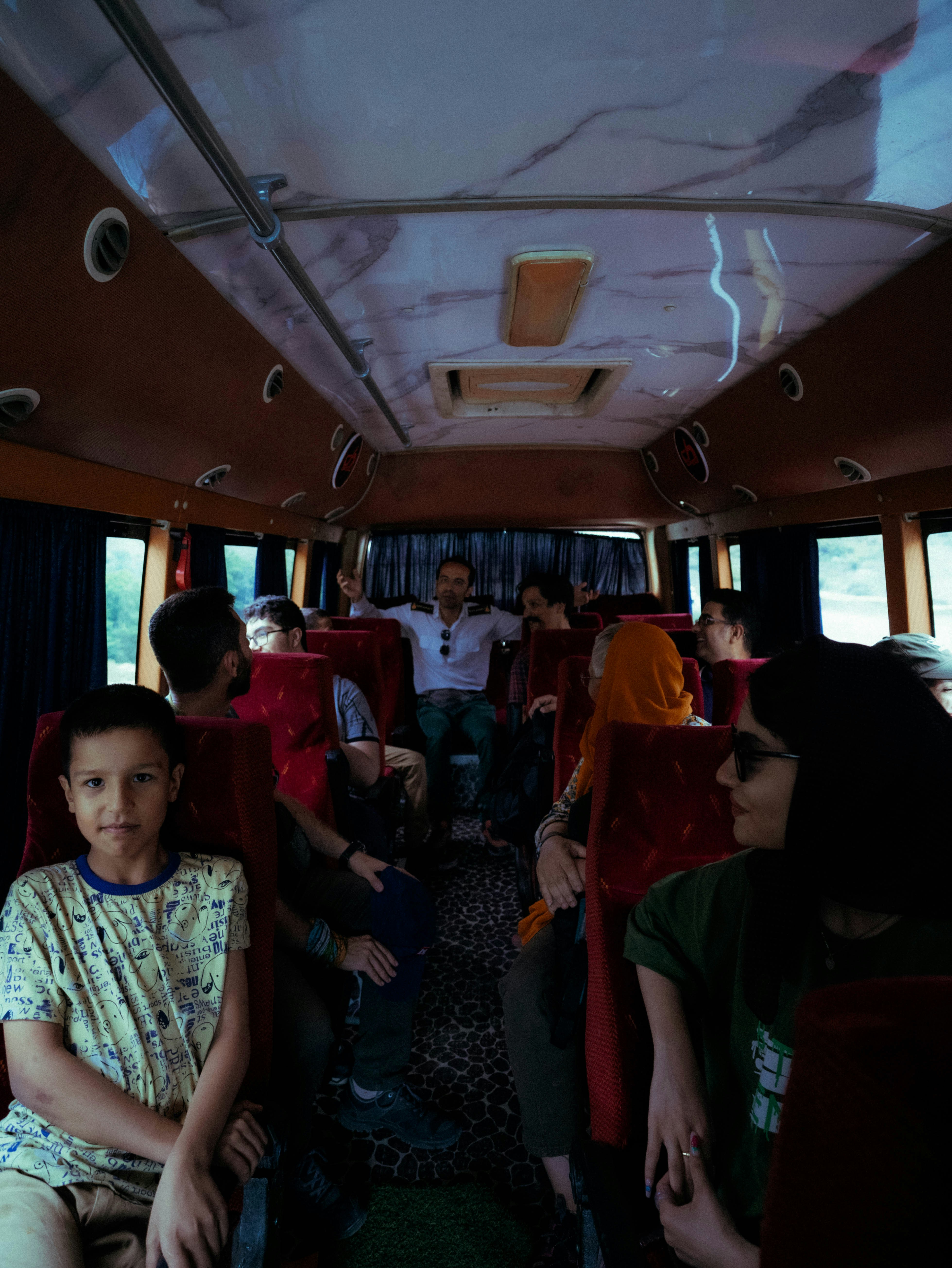 A group of people sitting on a bus