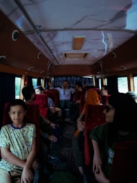 A group of people sitting on a bus