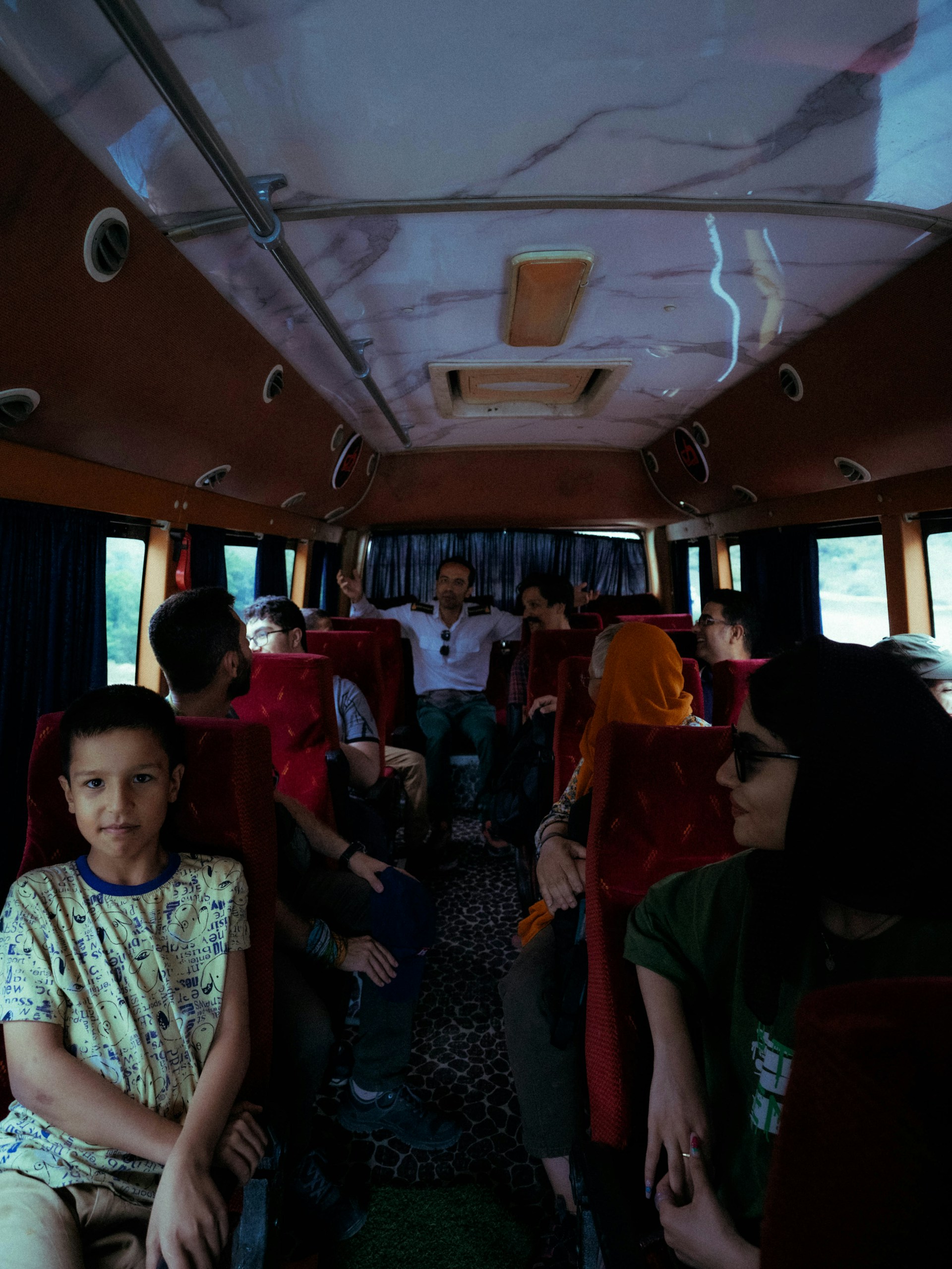 A group of people sitting on a bus