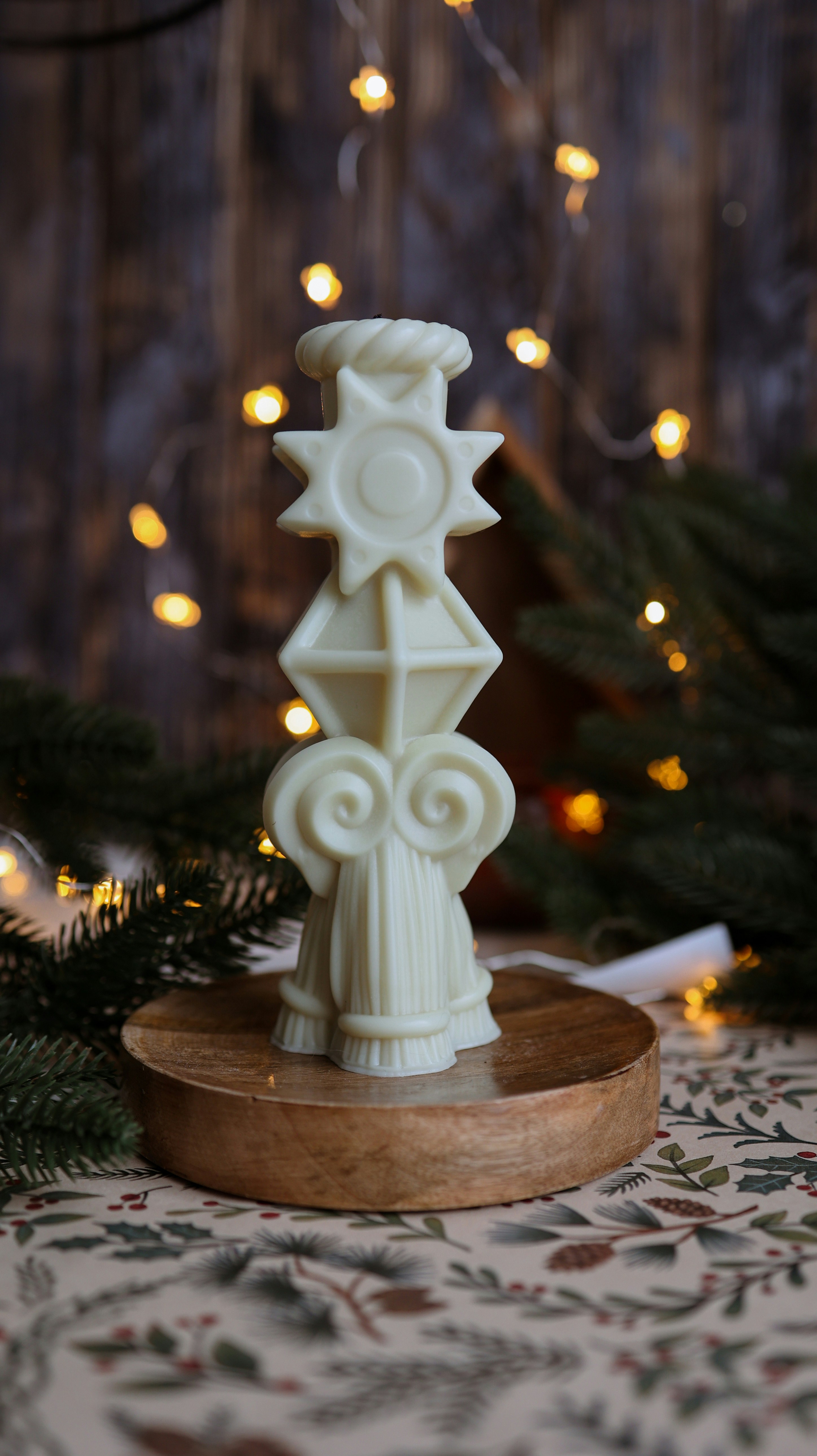 A white candle holder sitting on top of a table