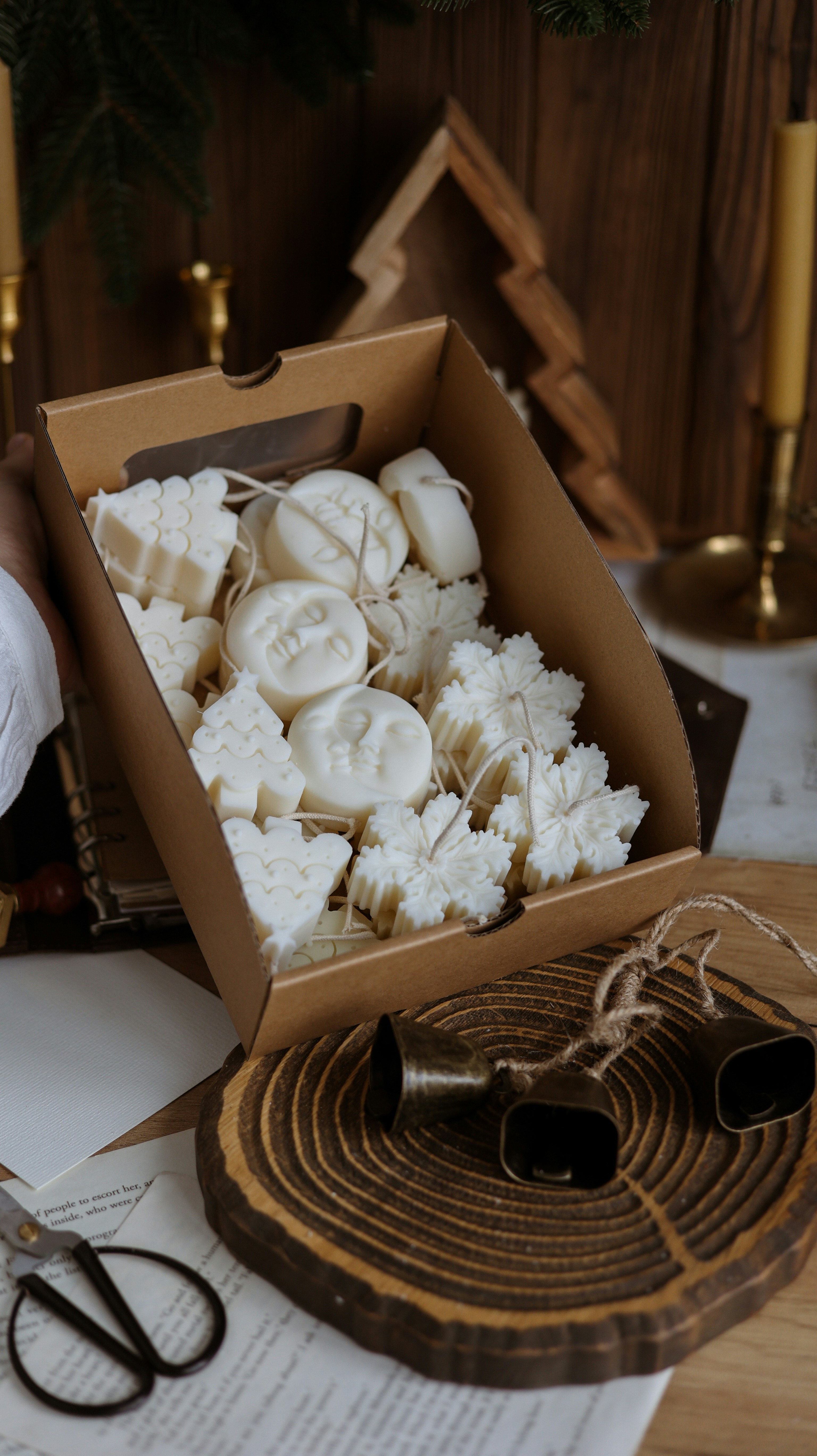 A box of bananas sitting on top of a table next to a pair of scissors