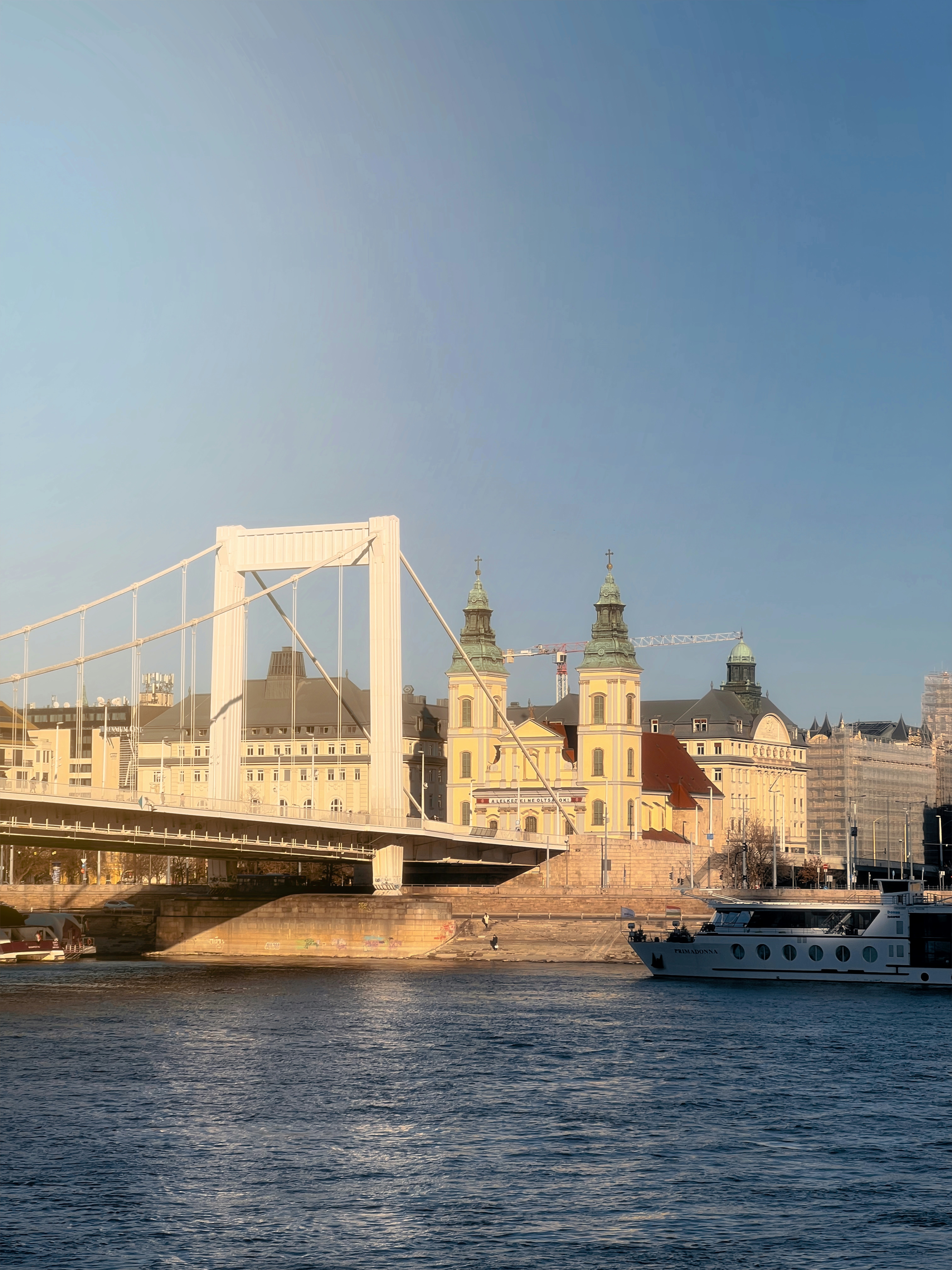 A bridge over a body of water next to a city