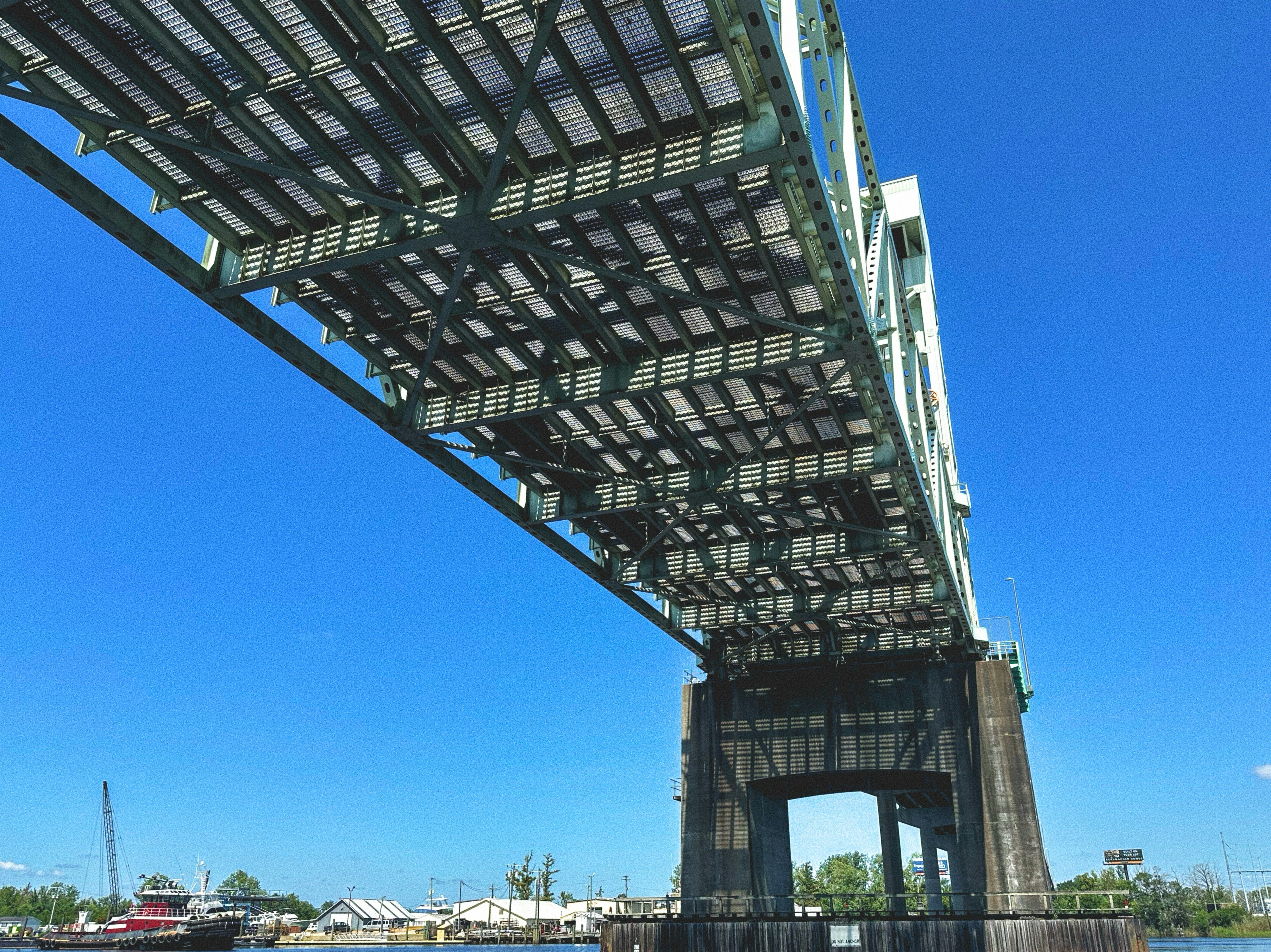 A view of the underside of a bridge over water