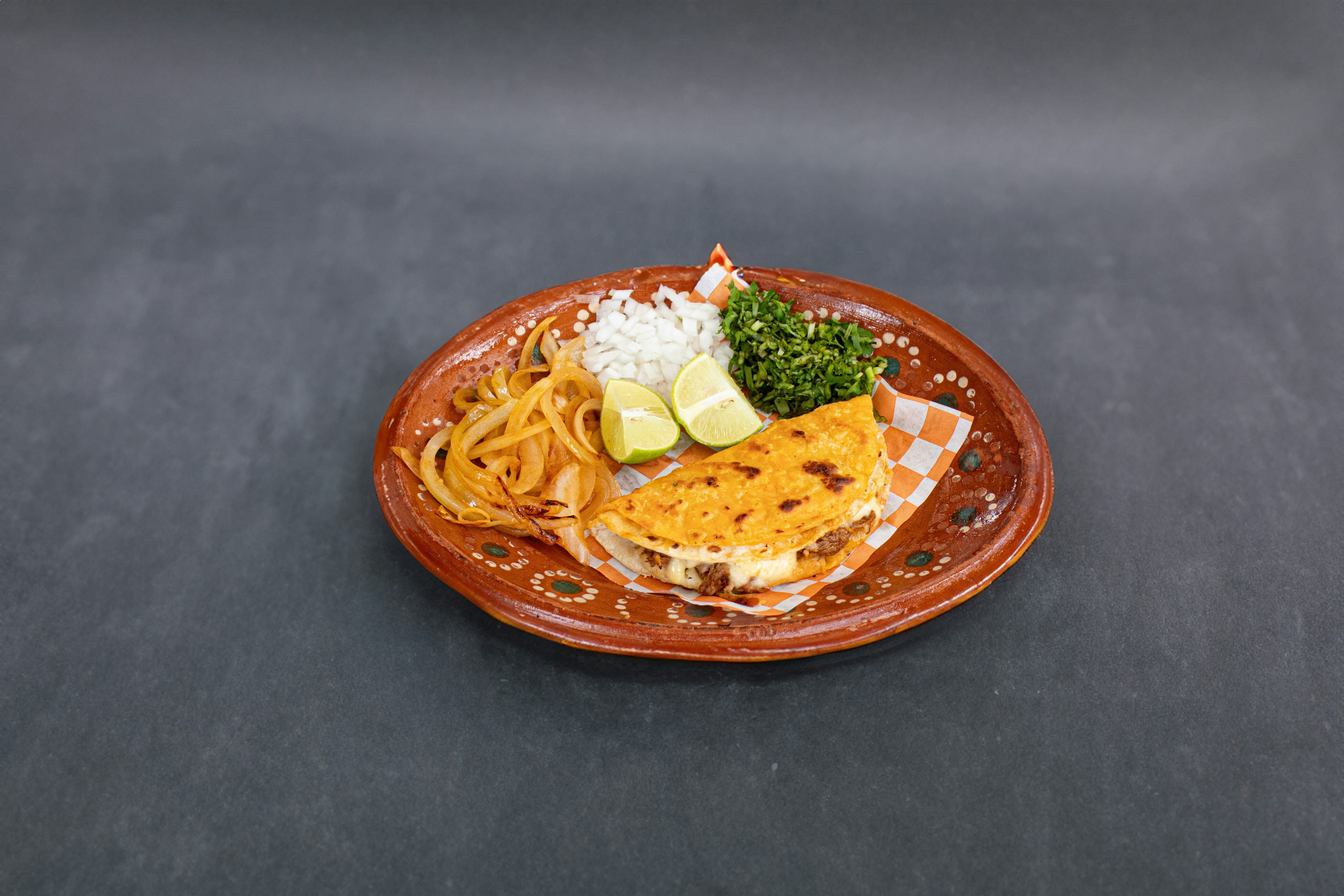 A plate of food on a black table