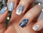 A person with a blue and white manicure with a tree on it