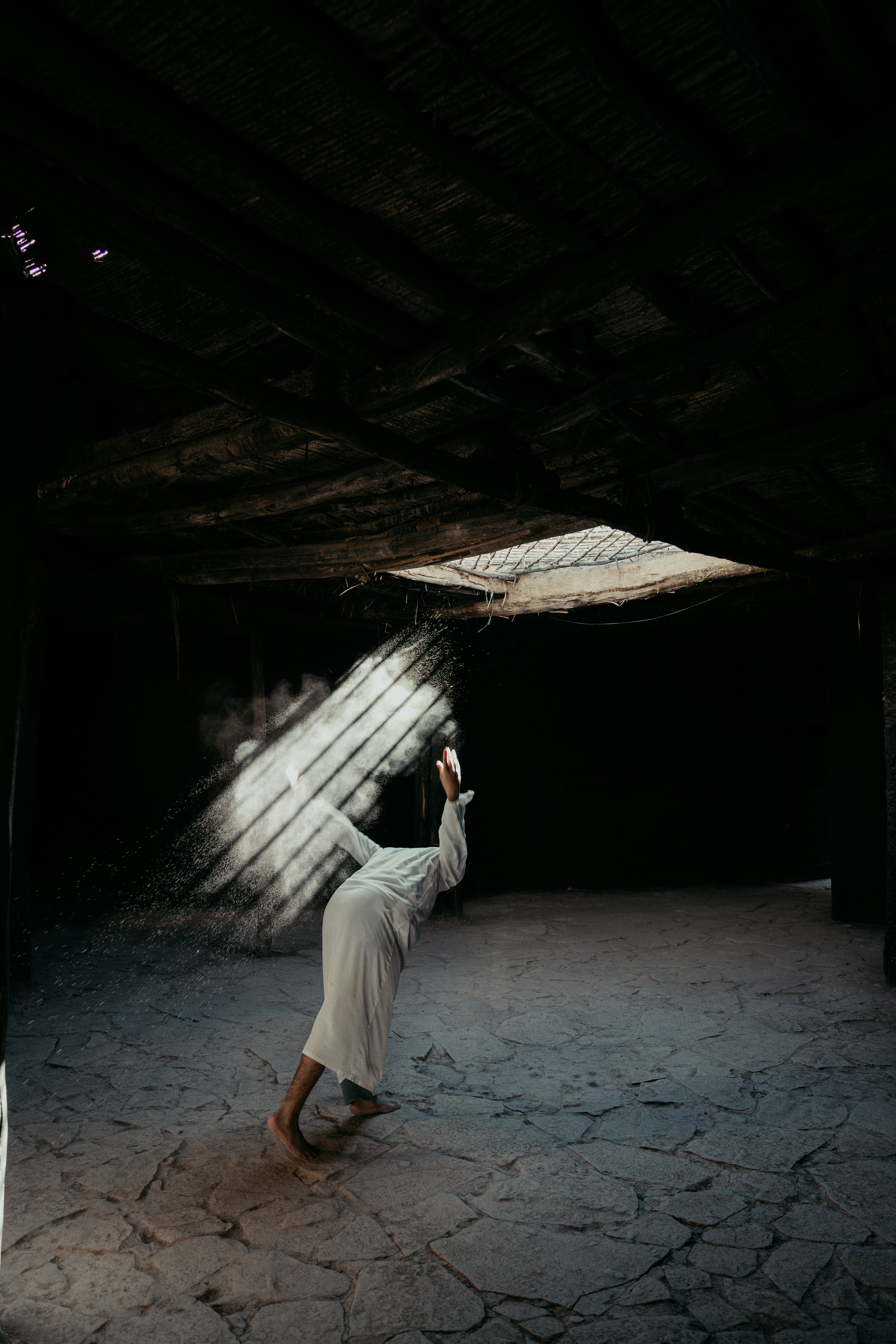 A person is walking in a dark room