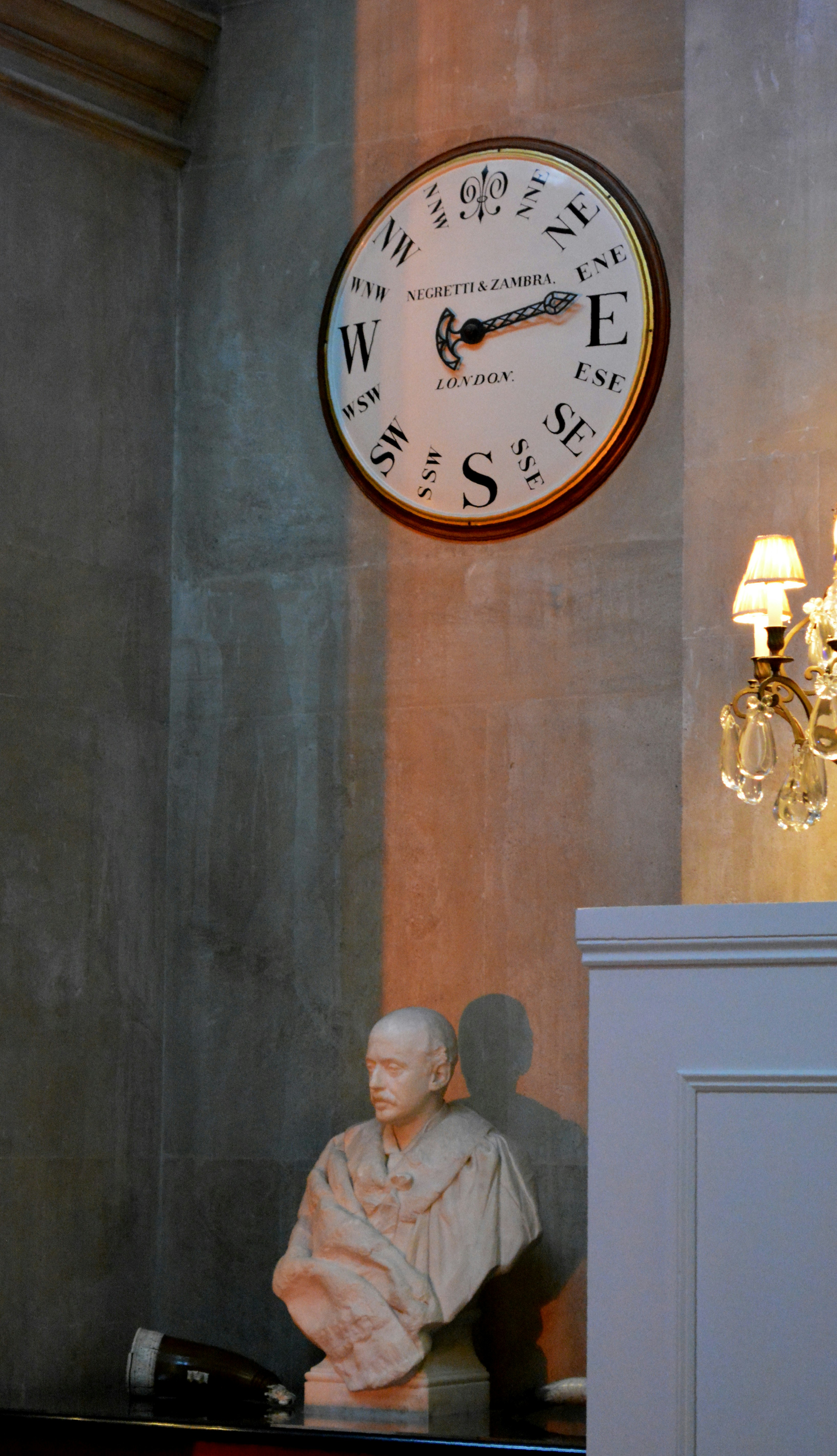 A large clock mounted to the side of a wall