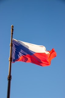 A red, white and blue flag flying in the wind
