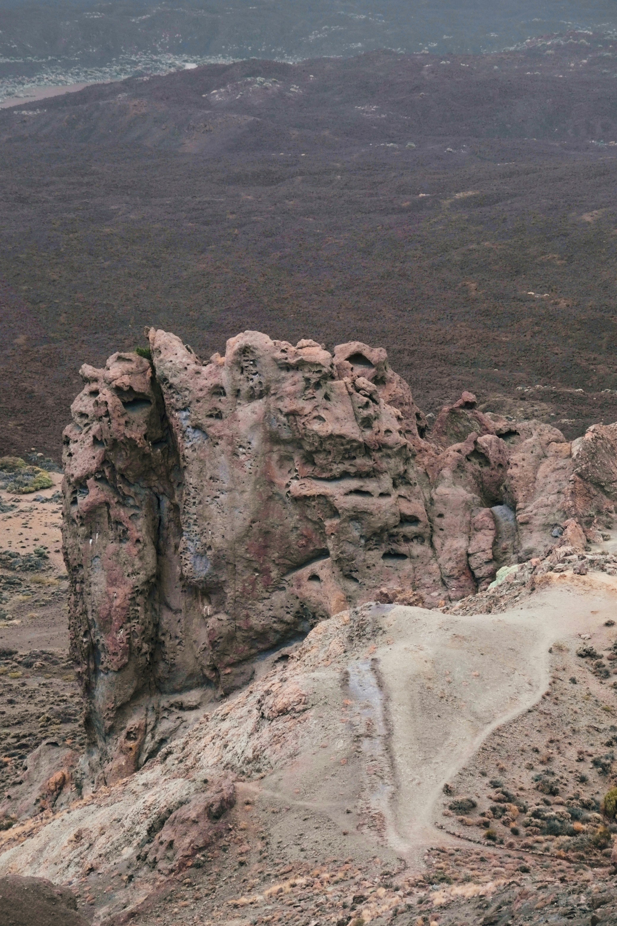 A man standing on top of a rocky mountain