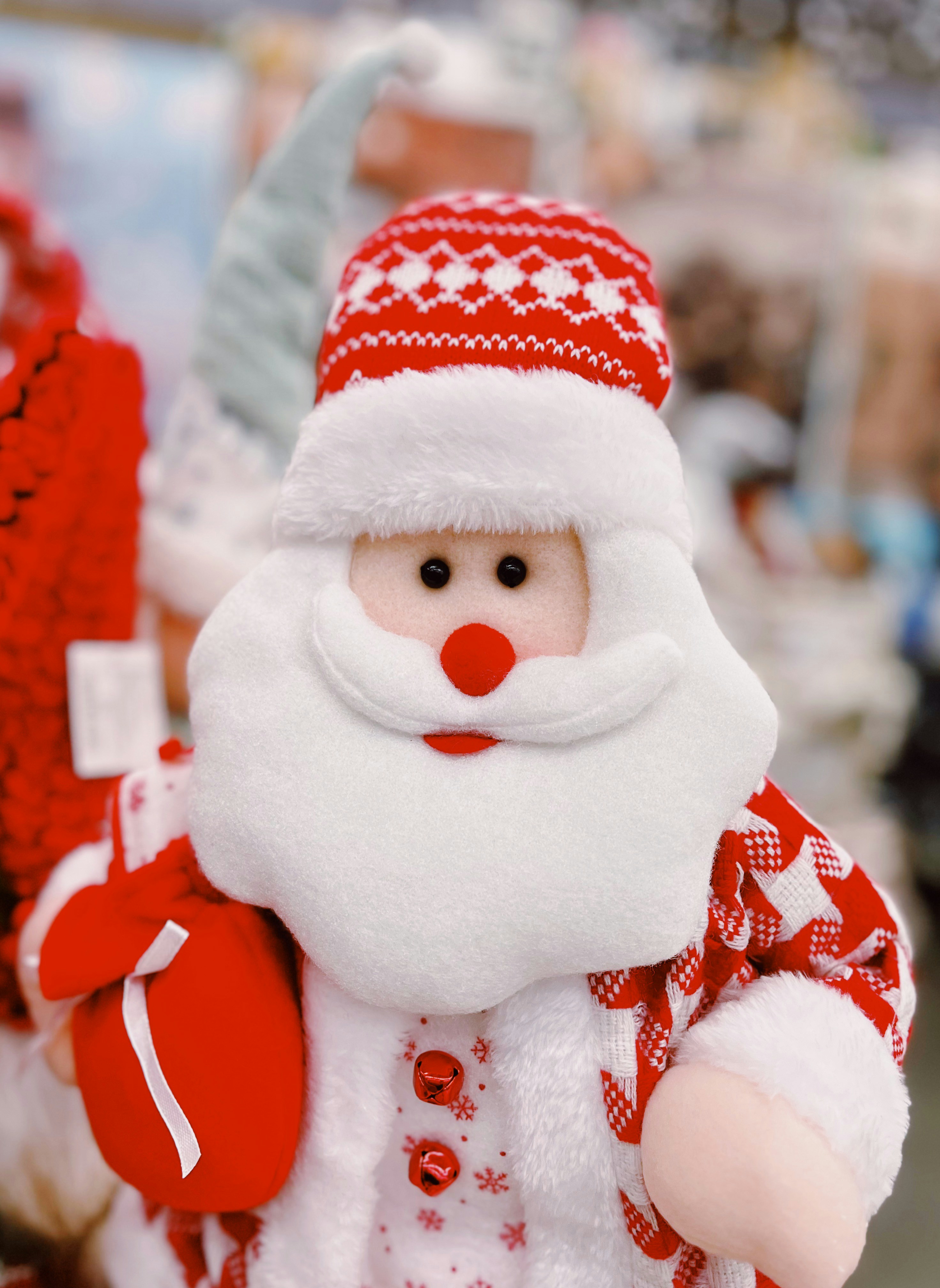 A close up of a santa clause holding a bag