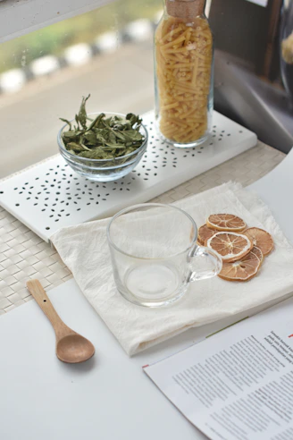 A table topped with a bowl of food and a glass of wine